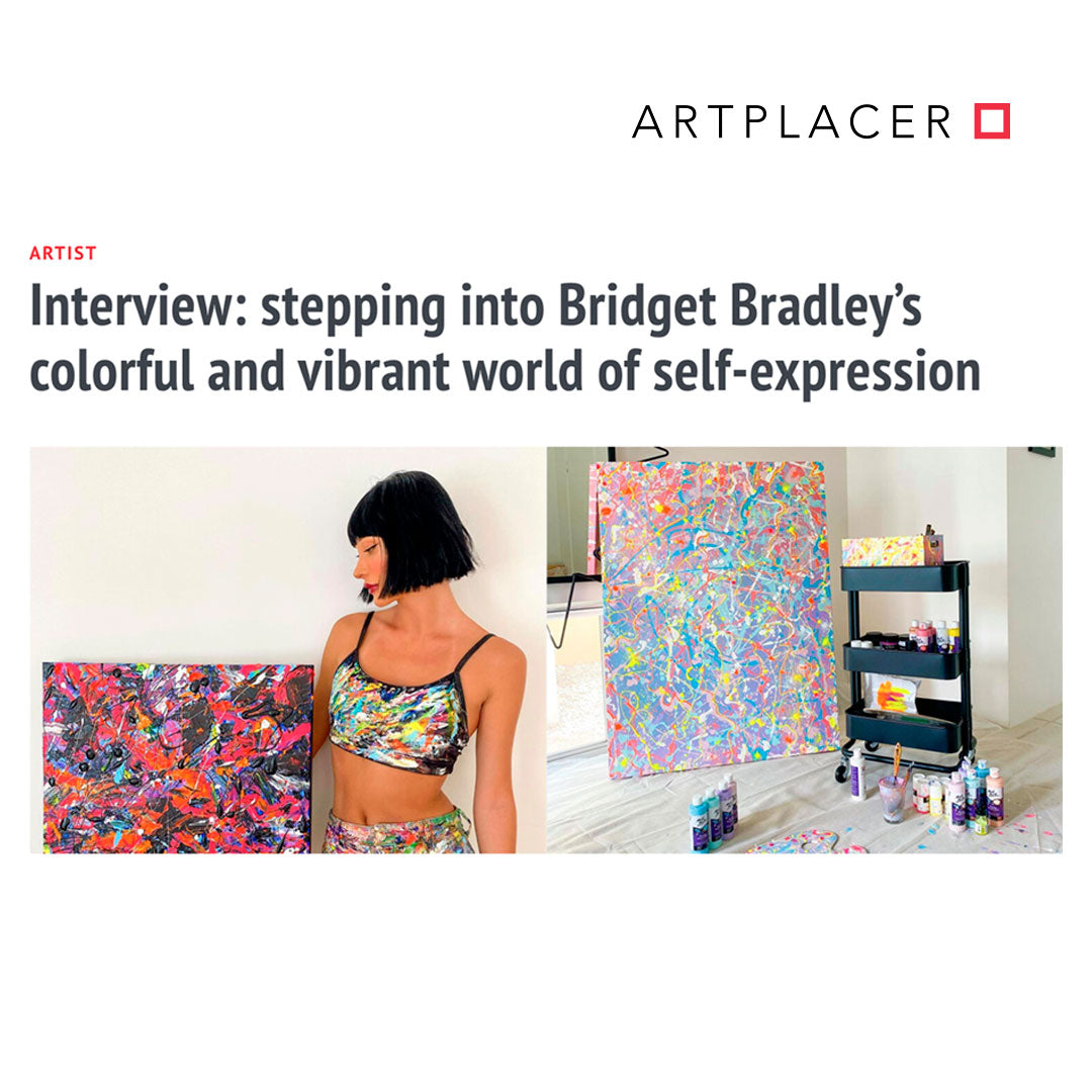 Bridget Bradley holds one of her original abstract paintings with a large abstract in the background 'Truth' and painting tools trolley. For Artplacer Artist Interview, July 2023