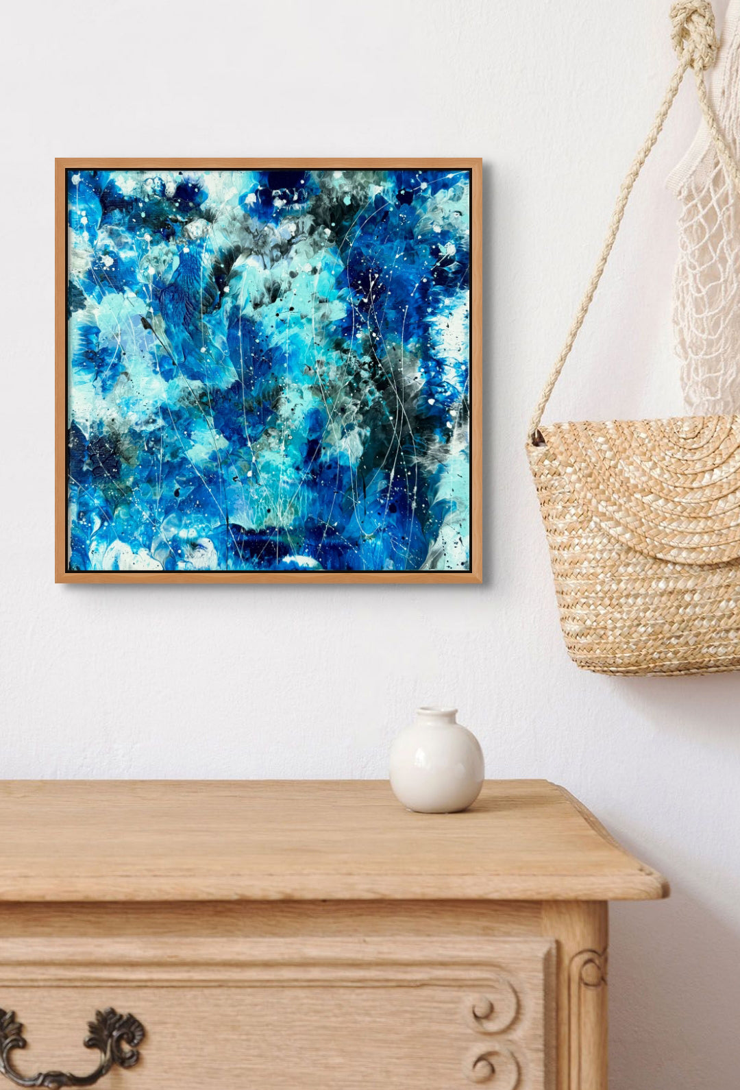 Image of original Abstract painting ' Azure Waters II' in open blues, custom Tasmanian Oak frame hanging above wooden drawers. Artwork by Bridget Bradley