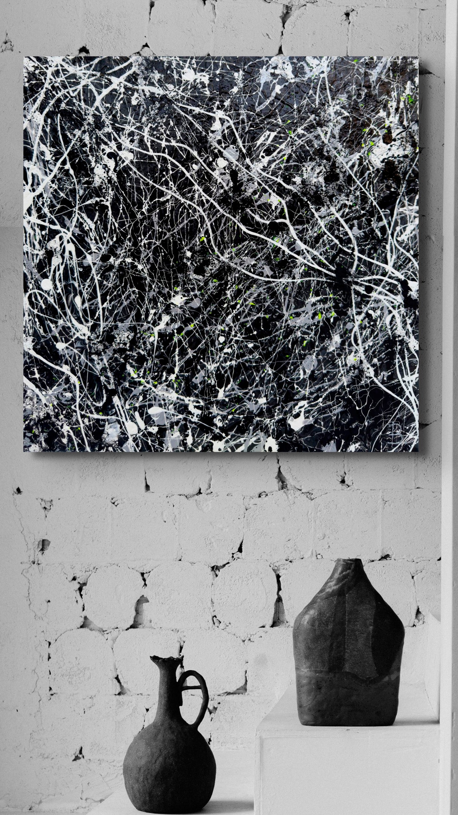 'Blackhat' by Bridget Bradley, contemporary black and white, textured abstract expressionism art on canvas, seen unframed hanging on white brick wall with two black pottery vases below