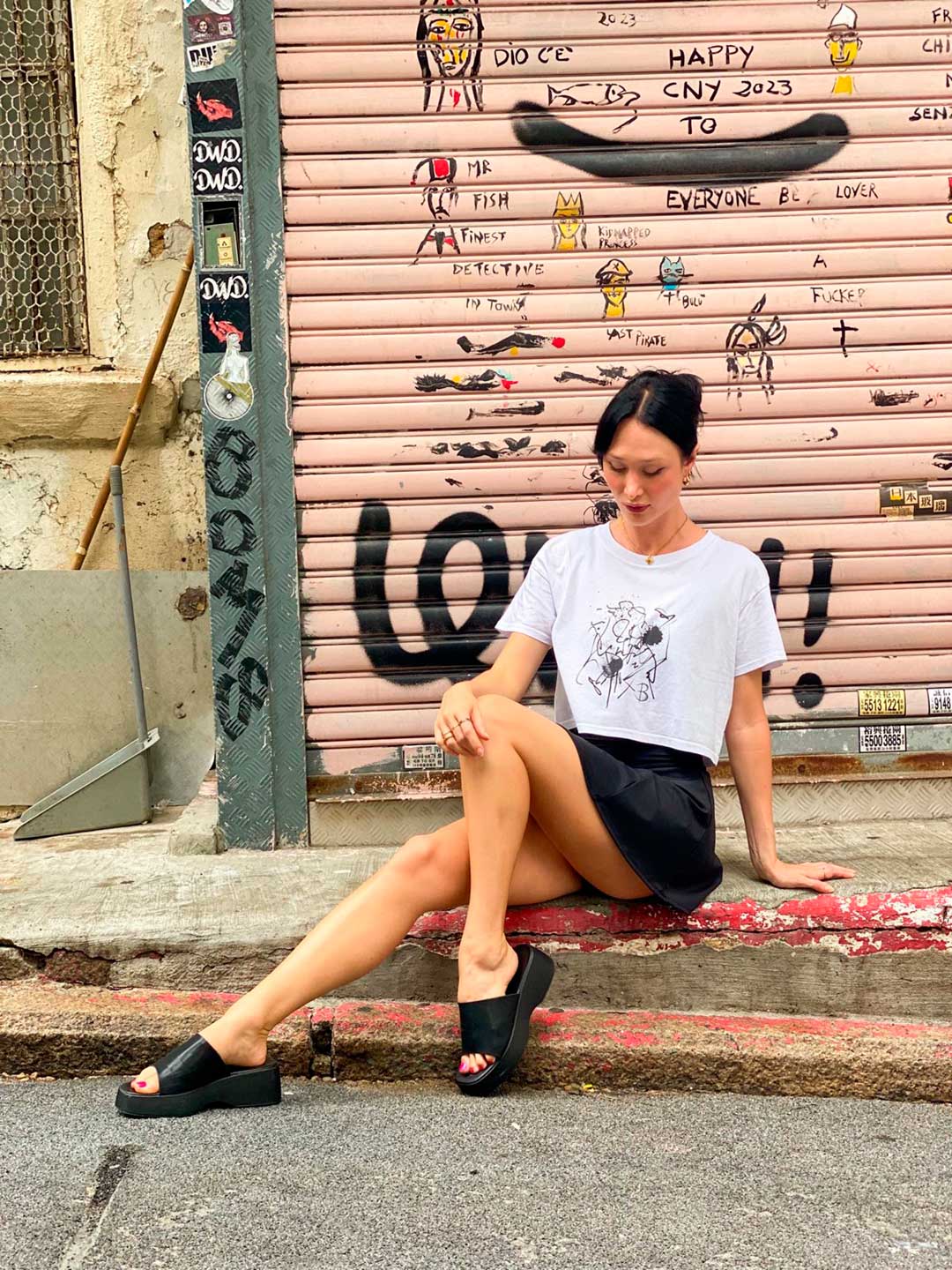 Bridget Models her B Contemporary Streetwear, The Eva Crop Top Tee, showing front design of tee.