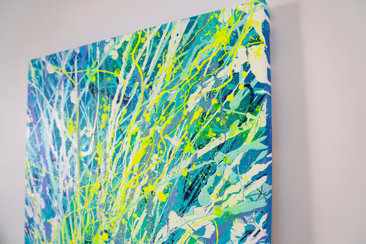'Luminescence' Original Abstract Painting left Side of Canvas. Bioluminescence inspired art in beautiful blues and neon yellow. View. Hand Painted by Abstract Expressionist Artist Bridget Bradley