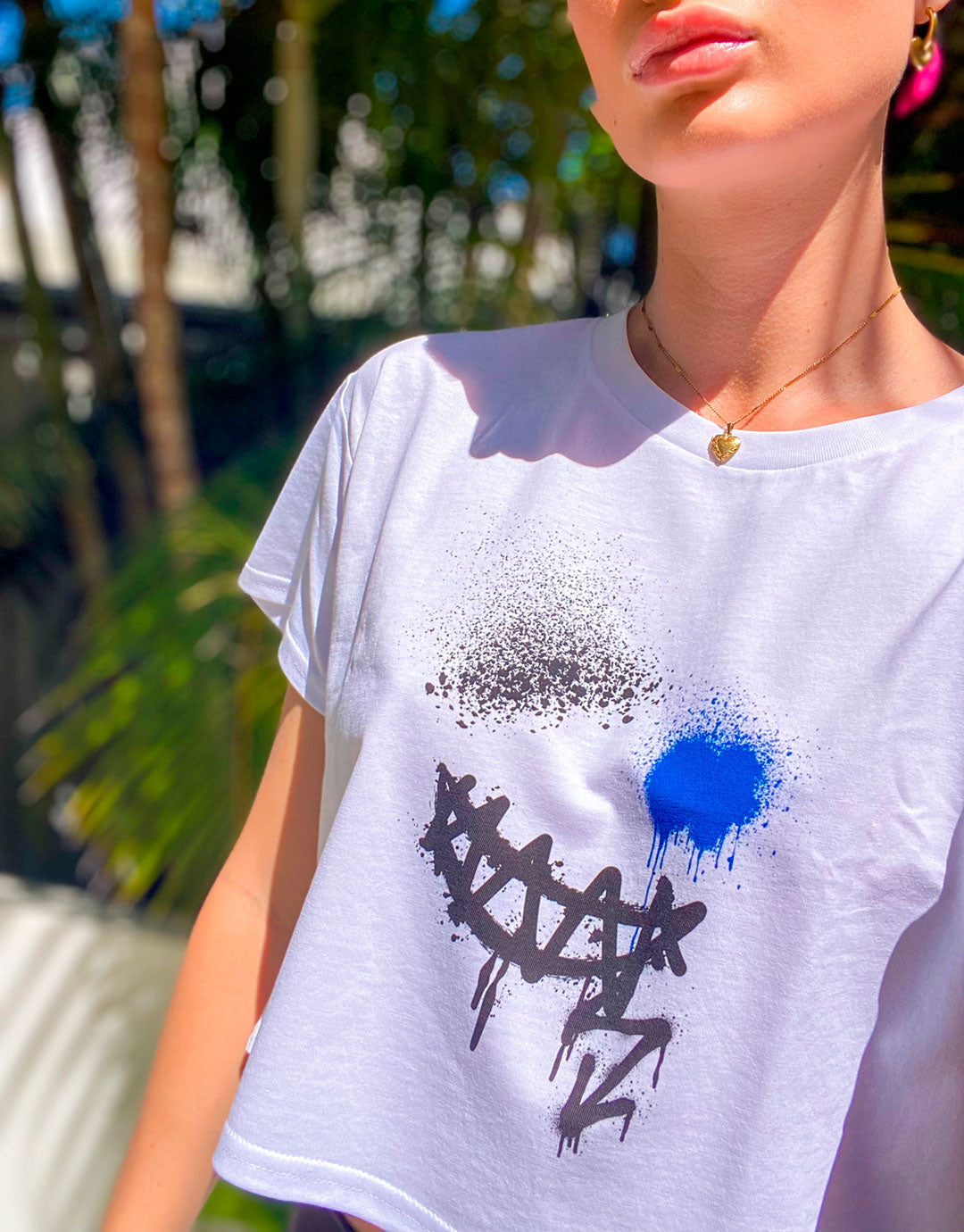 Bridget Models her B. Contemporary Streetwear a White Smile Crop Top Tee Showing the Front Design