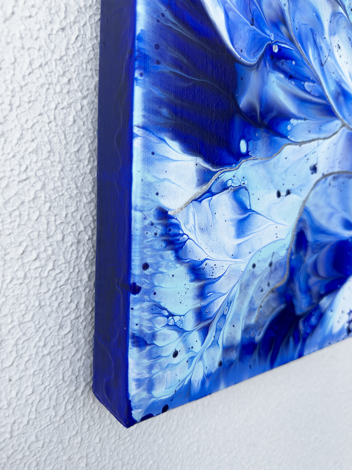 'Ocean Wings I' Original abstract expressionism painting lower right edge of canvas. Hand-painted mixed media with silver leaf by Bridget Bradley and seen hanging on white wall. Find out more.