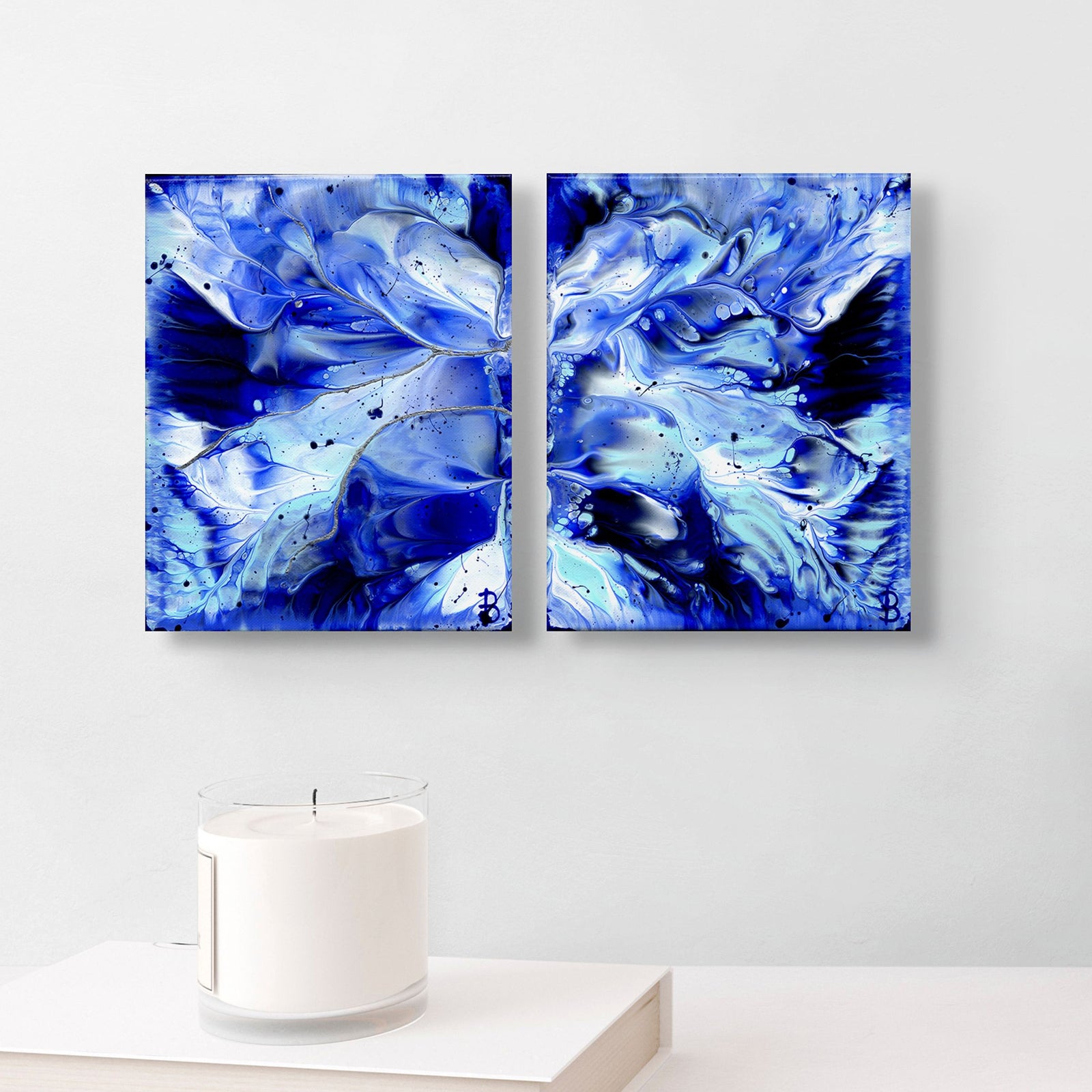 From Left: 'Ocean Wings I' and' Ocean Wings II' Abstract Paintings hanging on white wall above Candle. Learn more