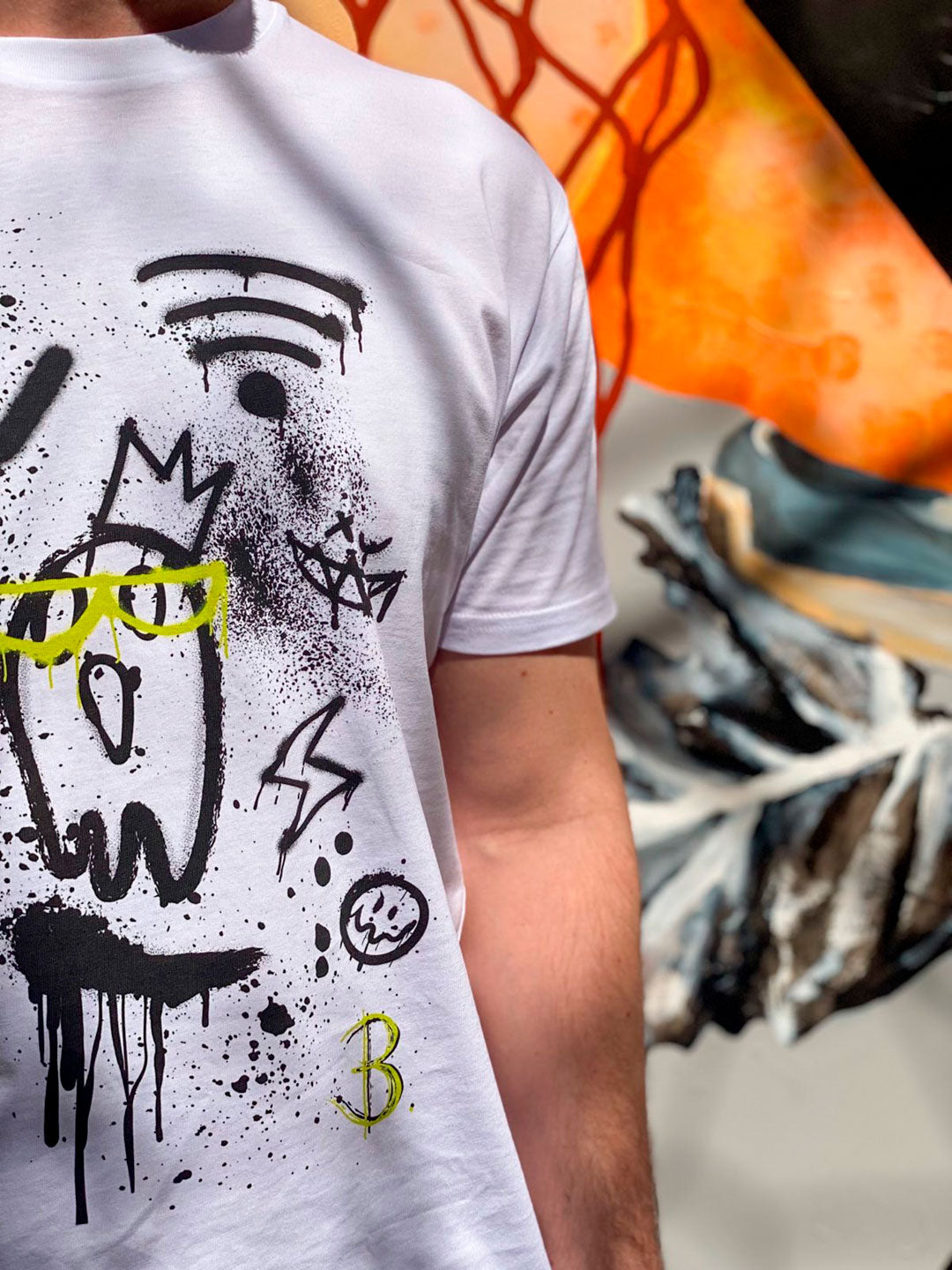 Off Grid T-Shirt Close Up Front Design against Colourful Background. Designer, high quality cotton tee in white, is mens or unisex. Design by Bridget Bradley, Abstract Artist and Designer