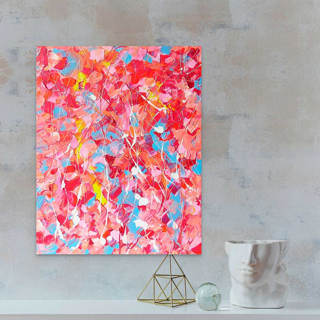 'Pink Lake', textured abstract painting, pinks, nudes, reds, blue, yellow and white palette. Seen in situ against concrete wall with modern decor.