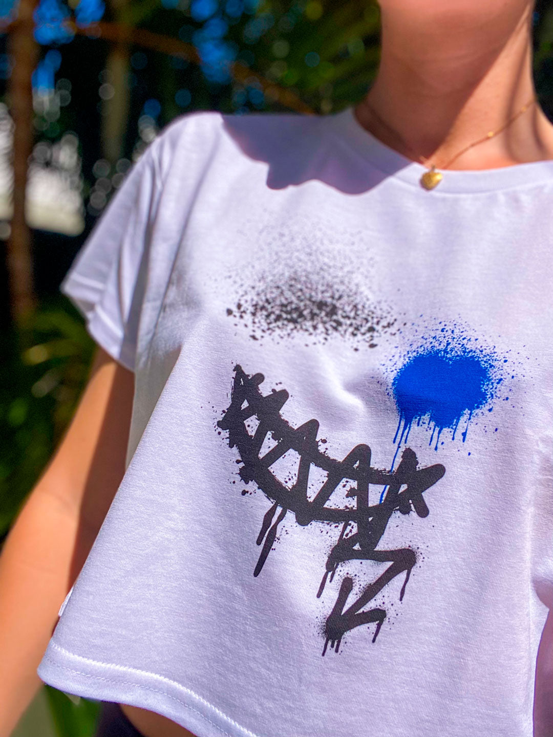 Model wear B. Contemporary Streetwear. Showing the Smile Crop Top White Tee Front Design Up Close. Designed by Bridget Bradley