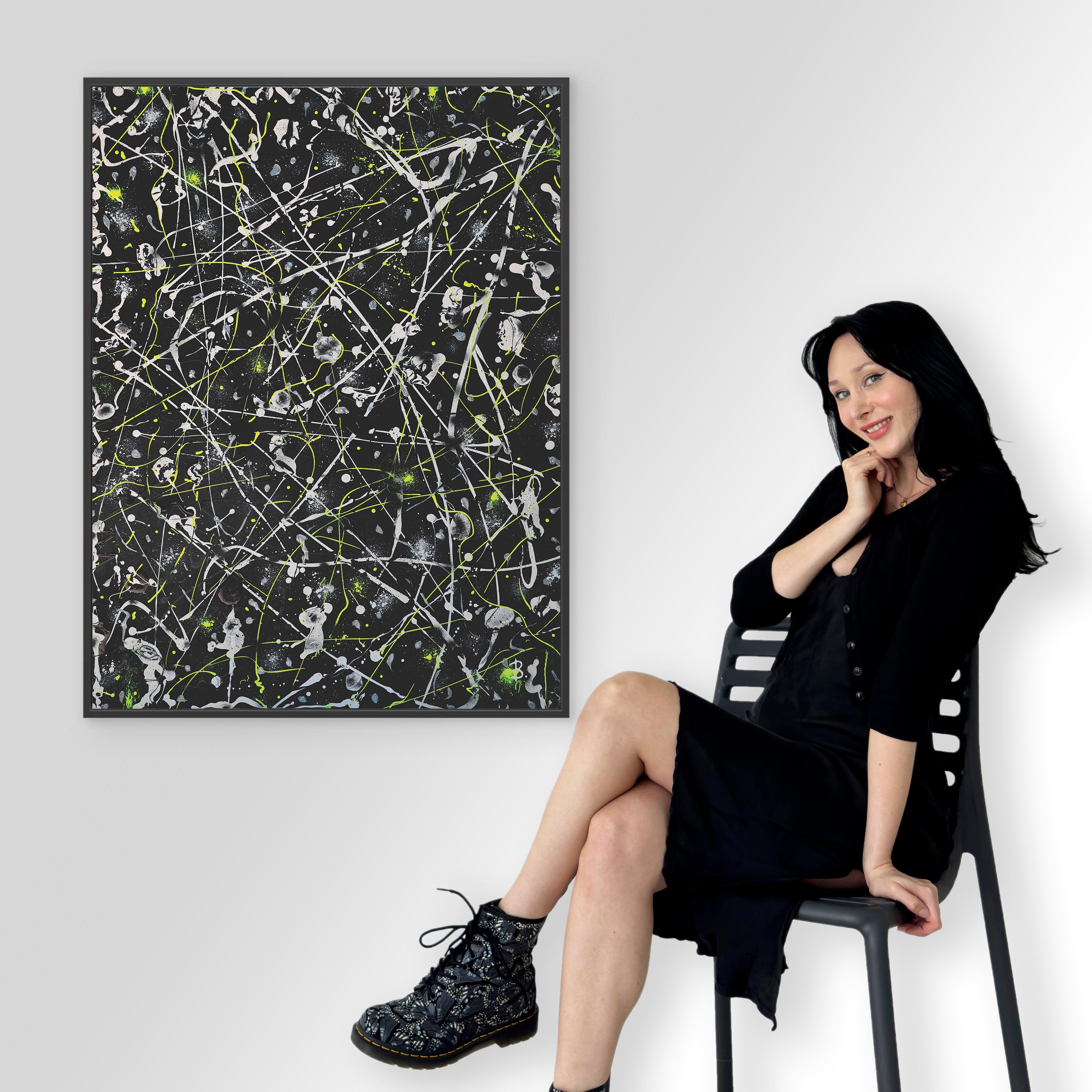 'Space Rock Canvas Print' with black frame and Bridget Bradley contemporary abstract artist sitting by the artwork. Learn more.