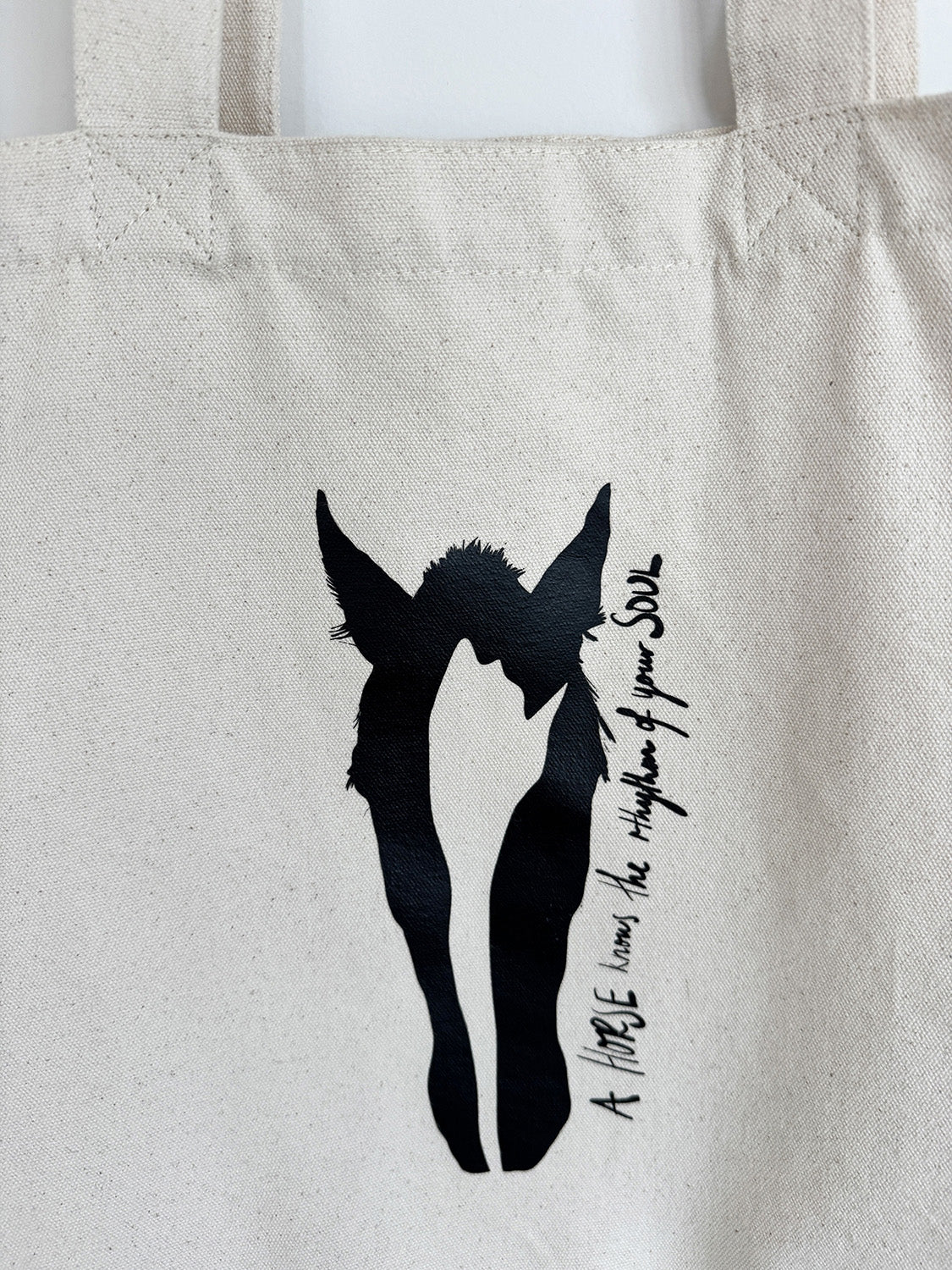 Closeup of exclusive Canvas 'A Horse's Soul' tote bag, with artist art print and quote. Artwork by Bridget Bradley.