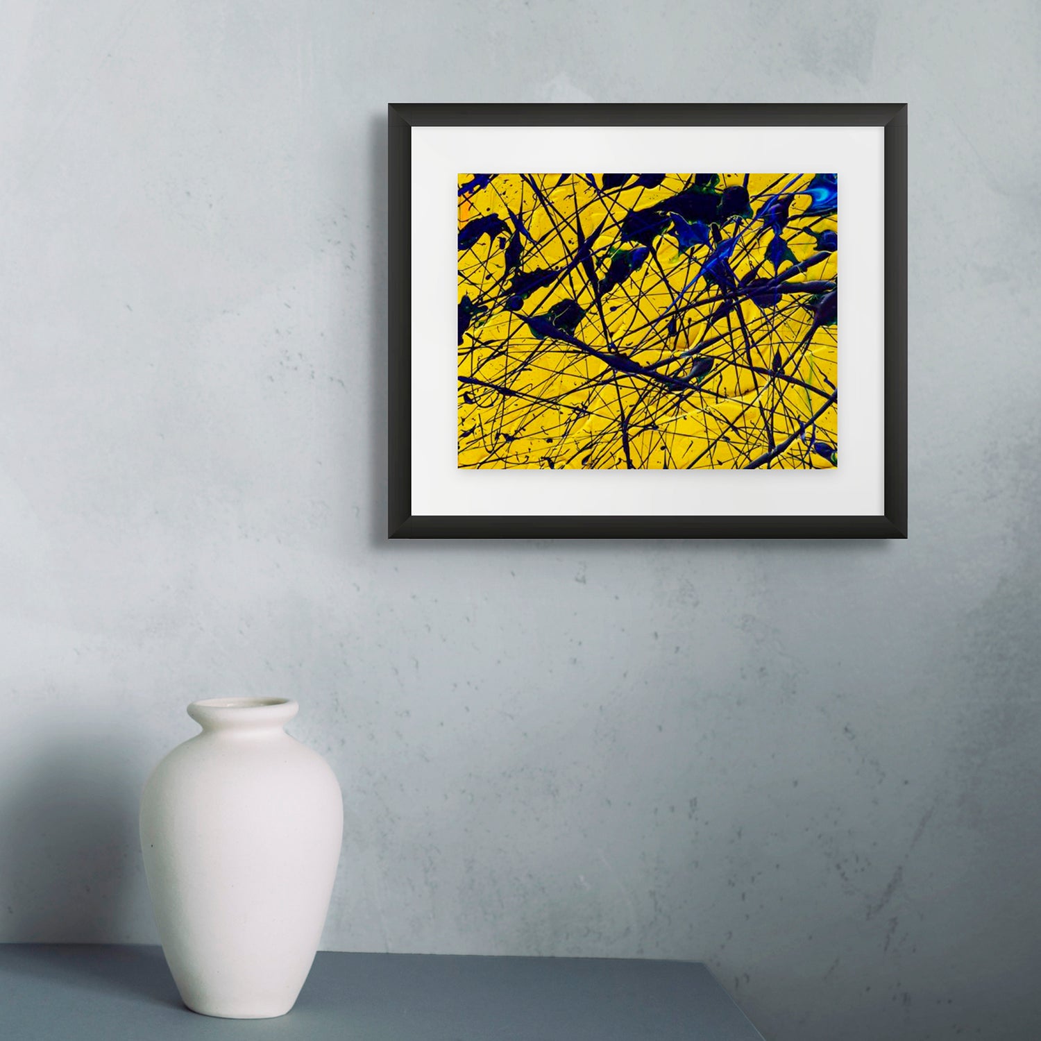 Yellow-Original Painting on Paper by Bridget Bradley Near Urn. Seen with Black Frame. Bright mini abstract paintings for sale.
