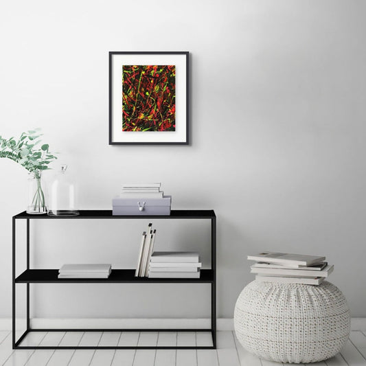 Light Through Dark, original abstract painting by Bridget Bradley seen hanging on white wall above a black console framed in black with a white mat.