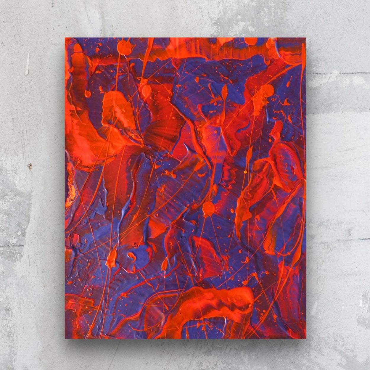 Little Luxuries VI, bold original abstract painting on paper by Bridget Bradley in reds and electric blues, seen against a stone wall in situ