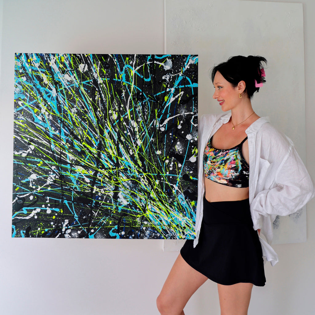 Bridget Bradley Visual Artist Holds Her Abstract painting 'Comet'