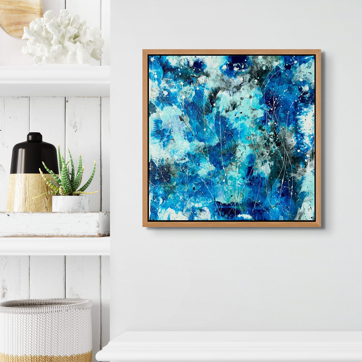 Closeup image of original abstract painting by Bridget Bradley, seen in custom Tasmanian Oak frame hanging on a  white wall near bookshelf. 