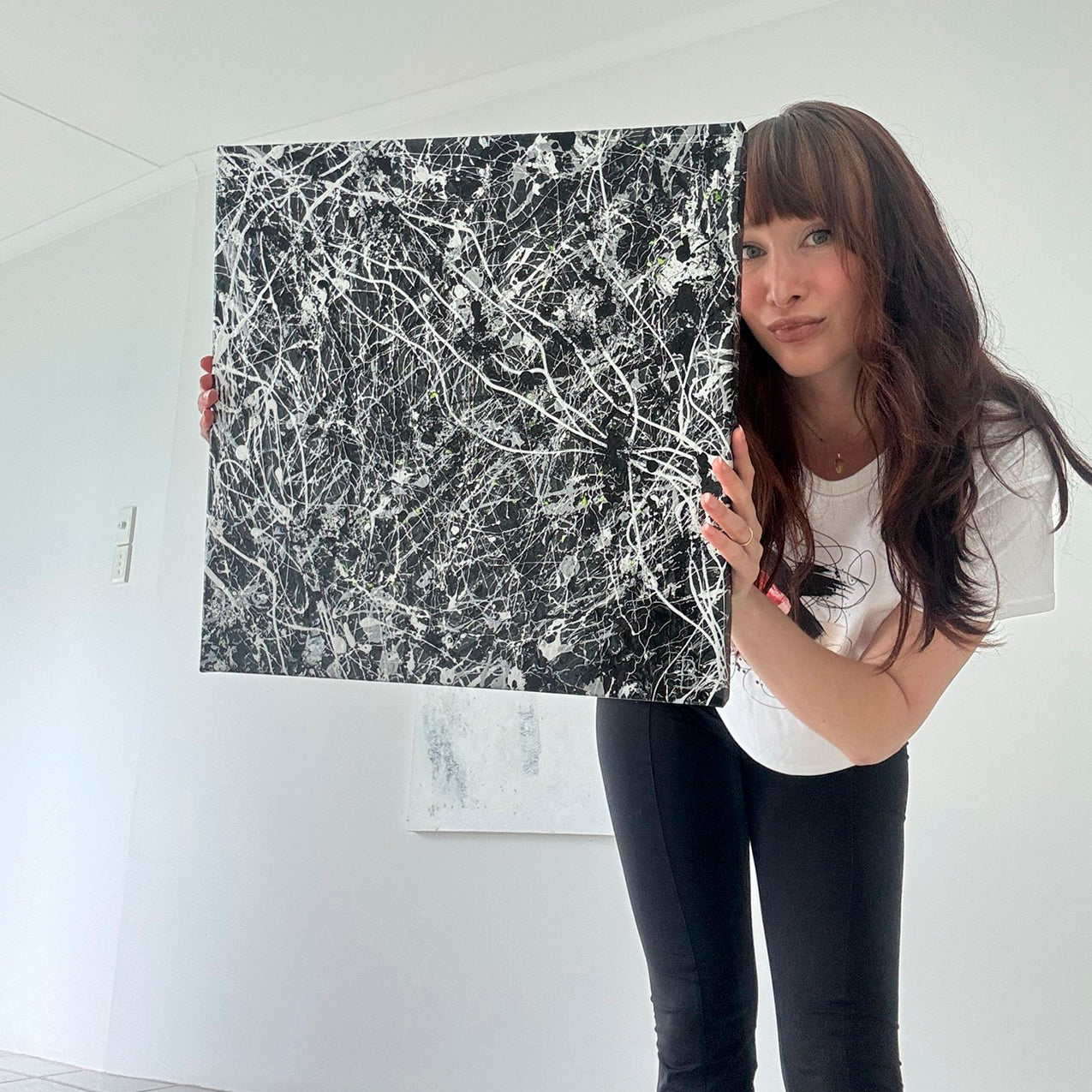 Bridget Bradley Contemporary Abstract Artist holds 'Blackhat' original, textured painting on canvas. 