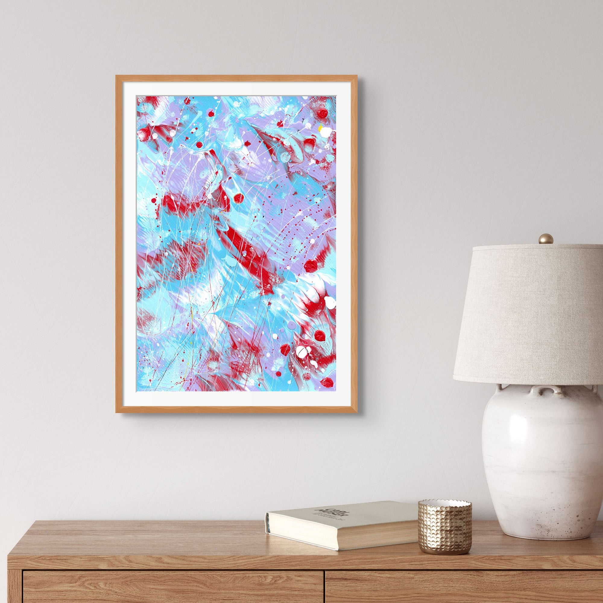 'Butterfly 6' Original Abstract Hand painted on Paper by Bridget Bradley. Seen framed in oak hanging near a neutral lamp, book and Peter ornament om Wooden furniture. Discover more about this beautiful abstract art