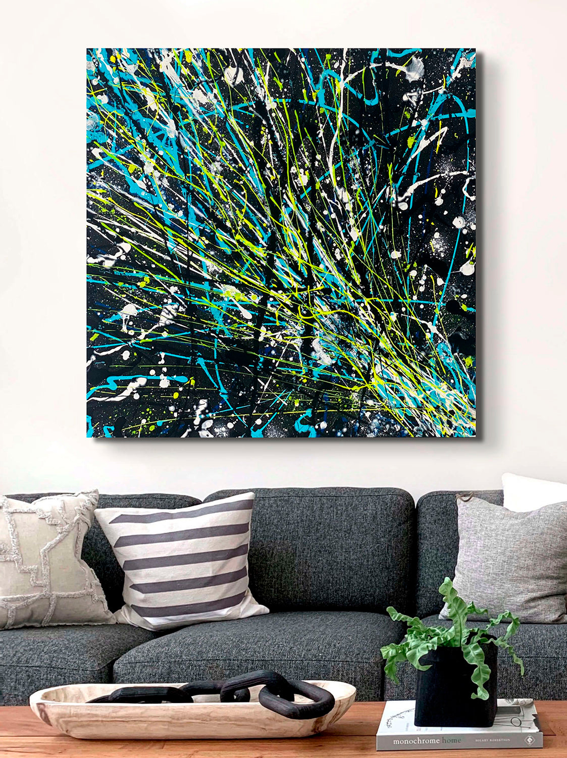 'Comet' Original Abstract Painting on canvas by Bridget Bradley, Vibrant , neon space art to capture your imagination, seen unframed above grey sofa and cushions. Modern contemporary art, Australia.
