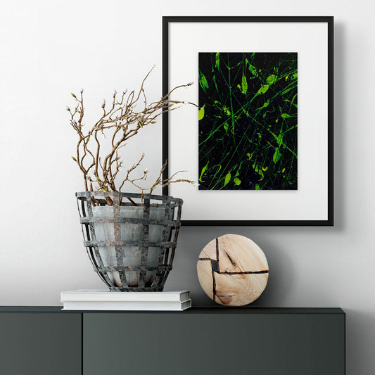'Complexity', original abstract art on paper with dark backfground and neon greens seen framed and hanging in situ with modern decor. Painted by Bridget Bradley