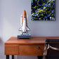 Cosmic, original abstract art by Brigdet Bradley. Brightly coloured and textured, commissioned artwork seen hanging above a desk by rocket model