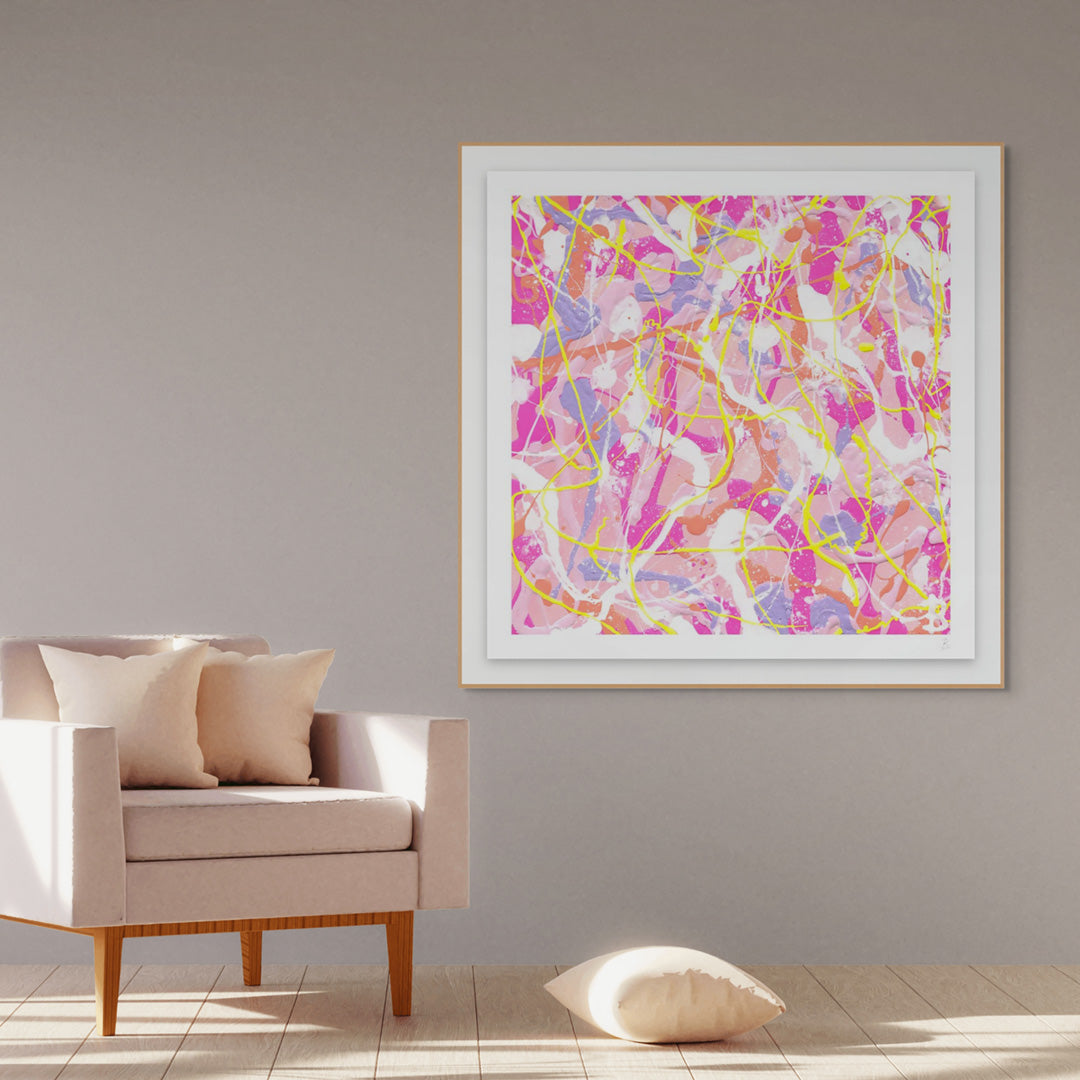 'Cupcake I' Fine Art Paper print seen in Oak Shadow Box Frame hanging on wall near chair and cushions. Large paper prints available framed or unframed