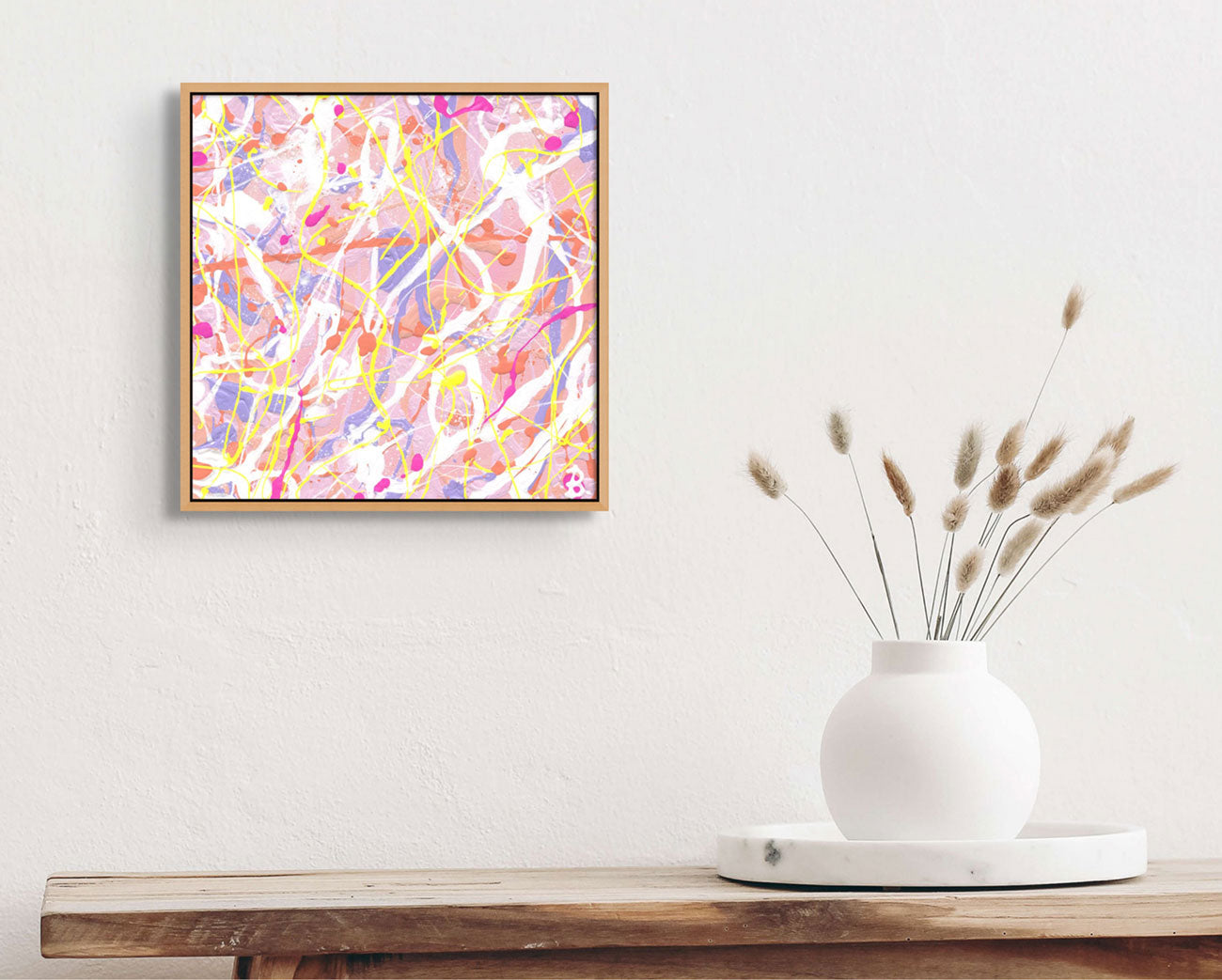 'Cupcake II' one of threee beautiful modern abstract paintings, hand painted by Bridget Bradley. Seen here if framed in oak above white vsae and tray on wooden table. Learn more about this one of a kind abstract original painting.