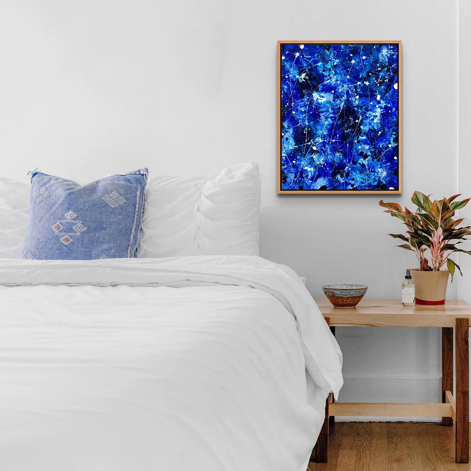 'DEEP BLUE I' original abstract painting with Tasmanian oak frame seen hanging in bedroom. Artwork created by Bridget Bradley.