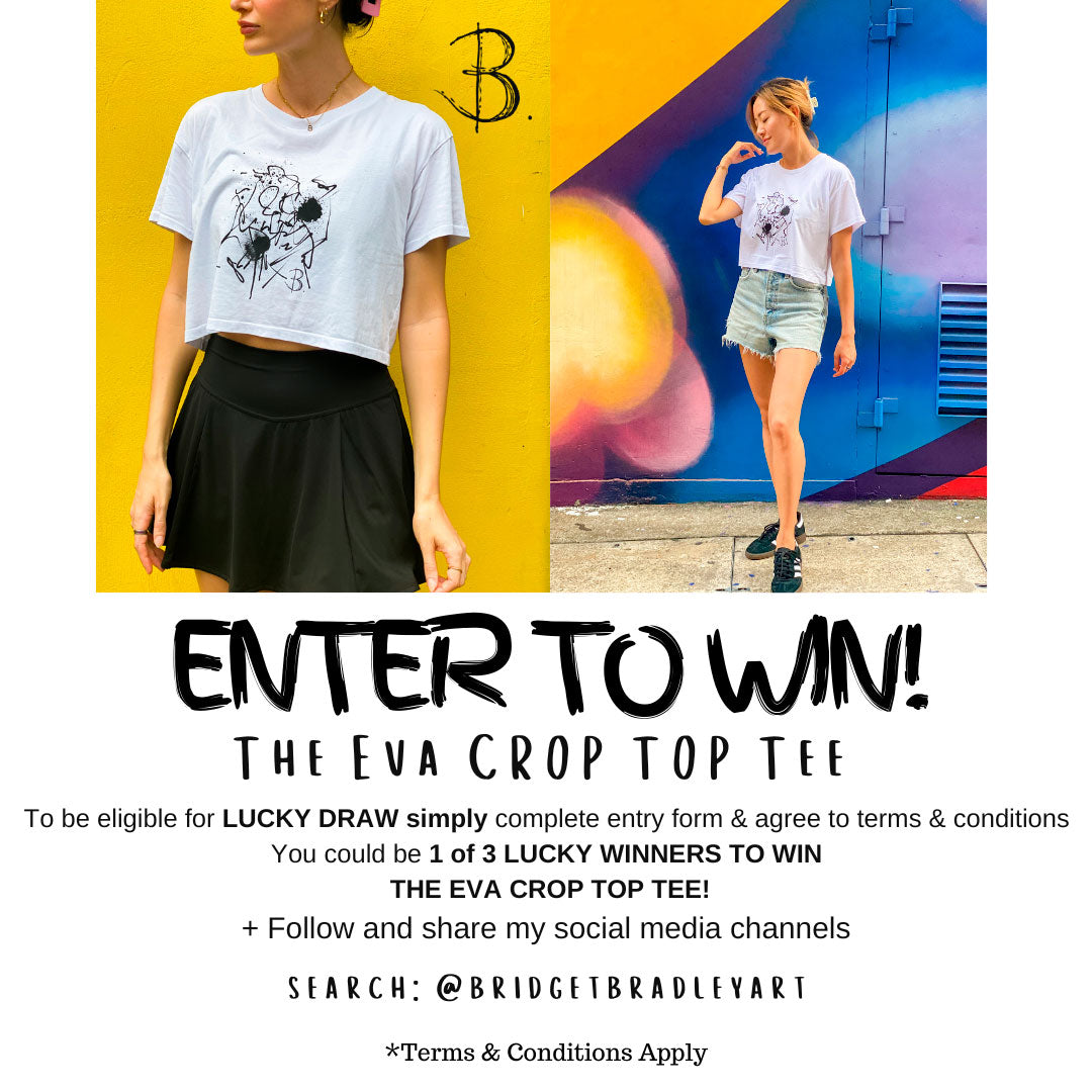 Models Wear The Eva Crop Top Tee stanf=ding against a colourful wall