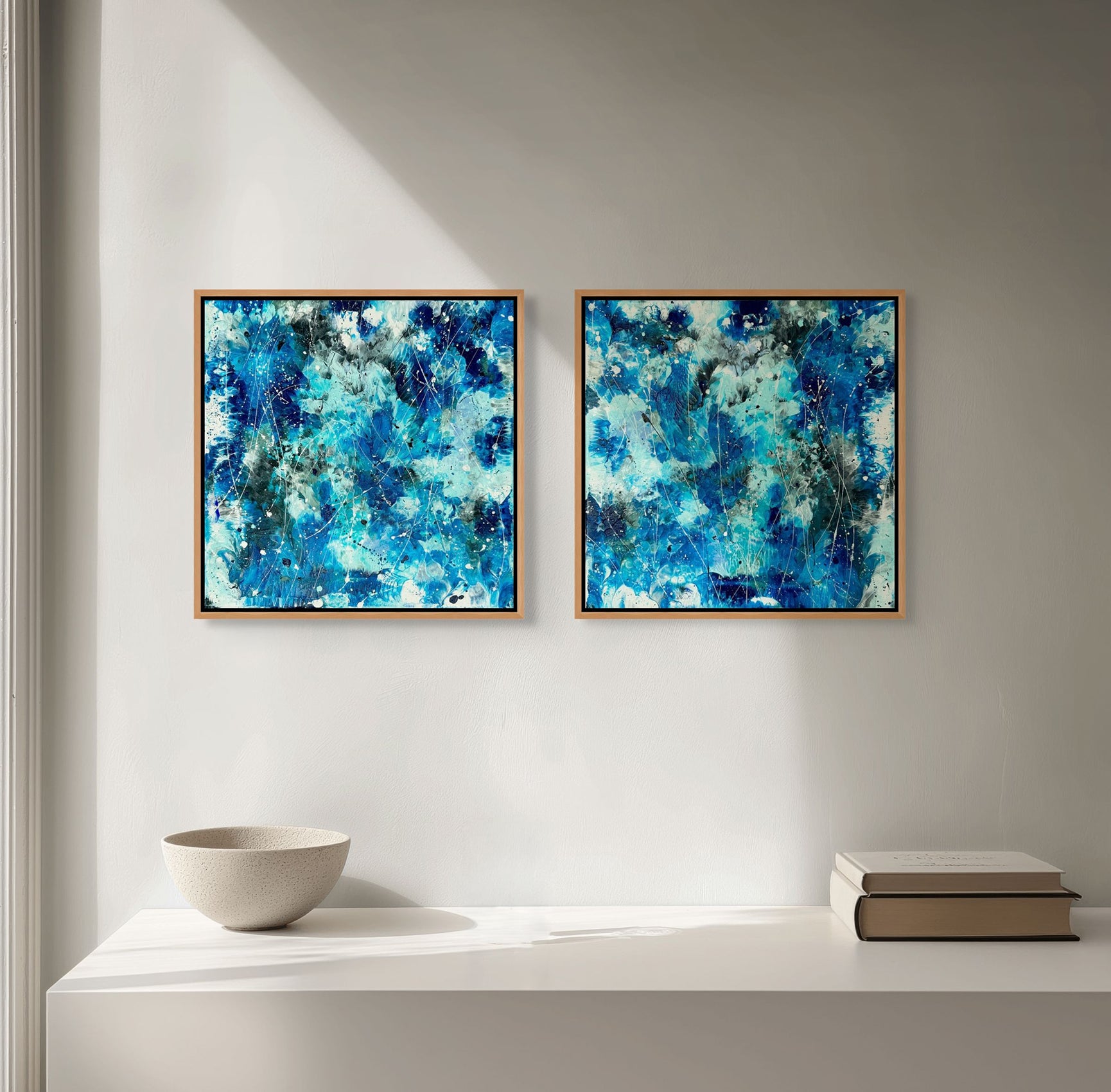 From Left: Azure Waters I and Azure Waters II original abstract expressionism paintings custom framed in Tasmanian Oak. Seen hanging in situ as a pair. Artwork by Bridget Bradley, contemporary Artist Queensland Australia
