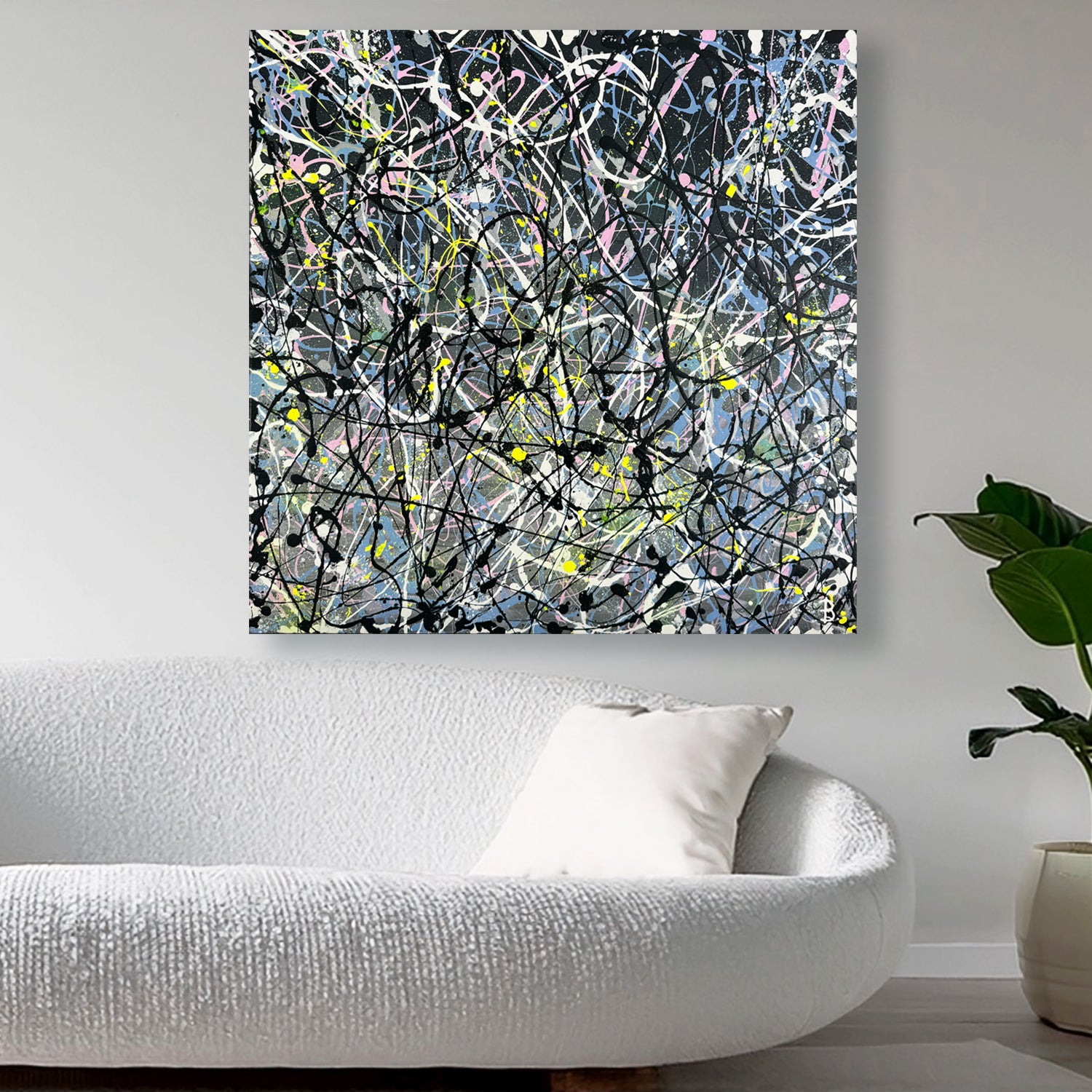 Contemporary abstract expressionism artwork in eon and bright pastel hues with black and white. 'GREY I' by Bridget Bradley on all above white sofa near pot plant.