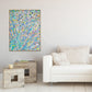 Iridescence, original abstract expressionism painting by Bridget Bradley, seen in oack frame hanging in living space with modern neutral decor