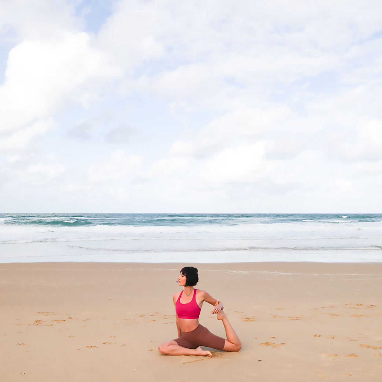 Bridget in King Pidgeon Pose variation on a sandy beach of Sunshine Coast. B. Yoga by Bridget Bradley