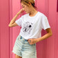 Model Stands against Pink Background Wearing The Eva Crop Top Tee. B Contemporary Streetwear  designed by Bridget Bradley