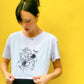 B. Contemporary Streetwear, Model Stands against yellow background wall, wears The Eva Crop Top Tee showing front., Black Design by Bridget Bradley