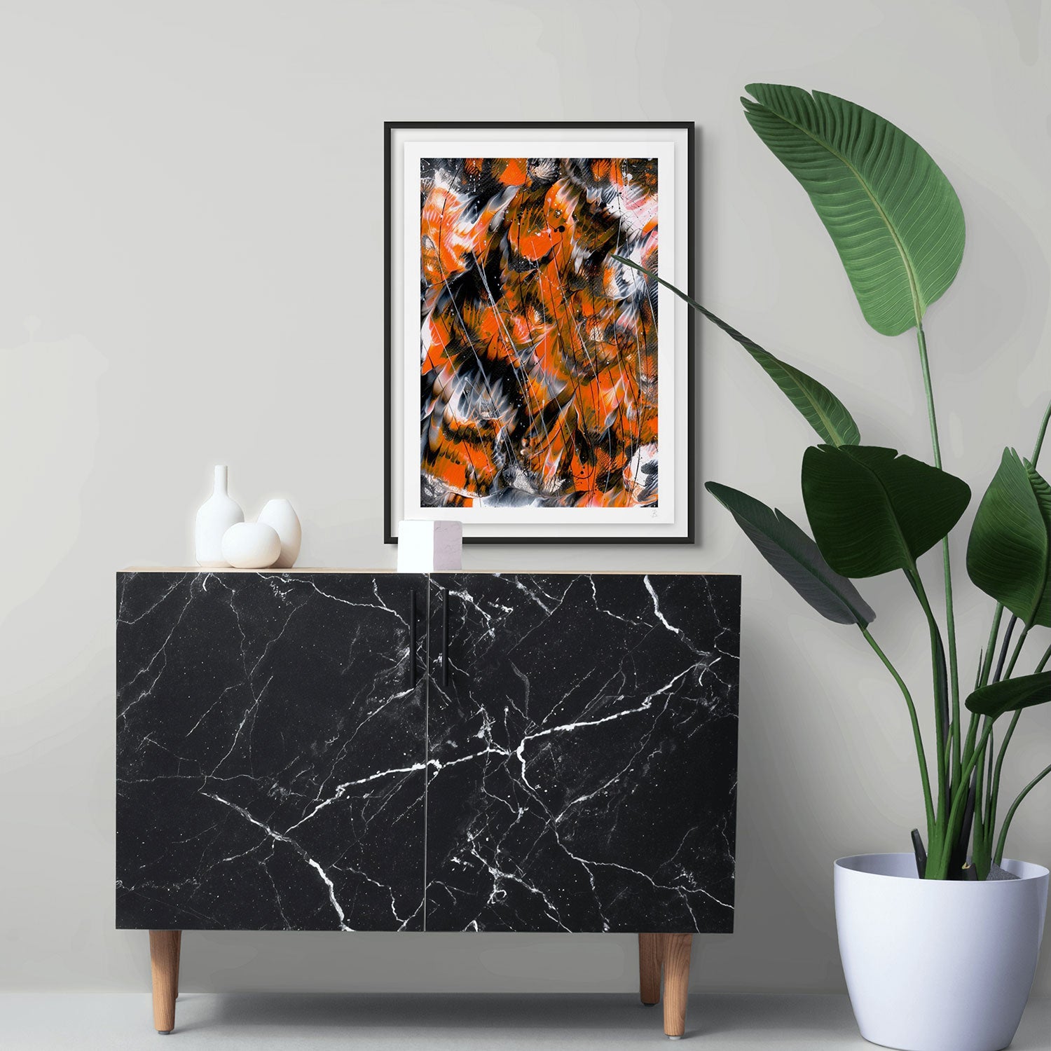 'Monarch 2' Fine Art Print on Paper Black Frame Hanging Above Black Console near Pot Plant. After original abstract painting by Bridget Bradley, Abstract expressionism Artist, Australia