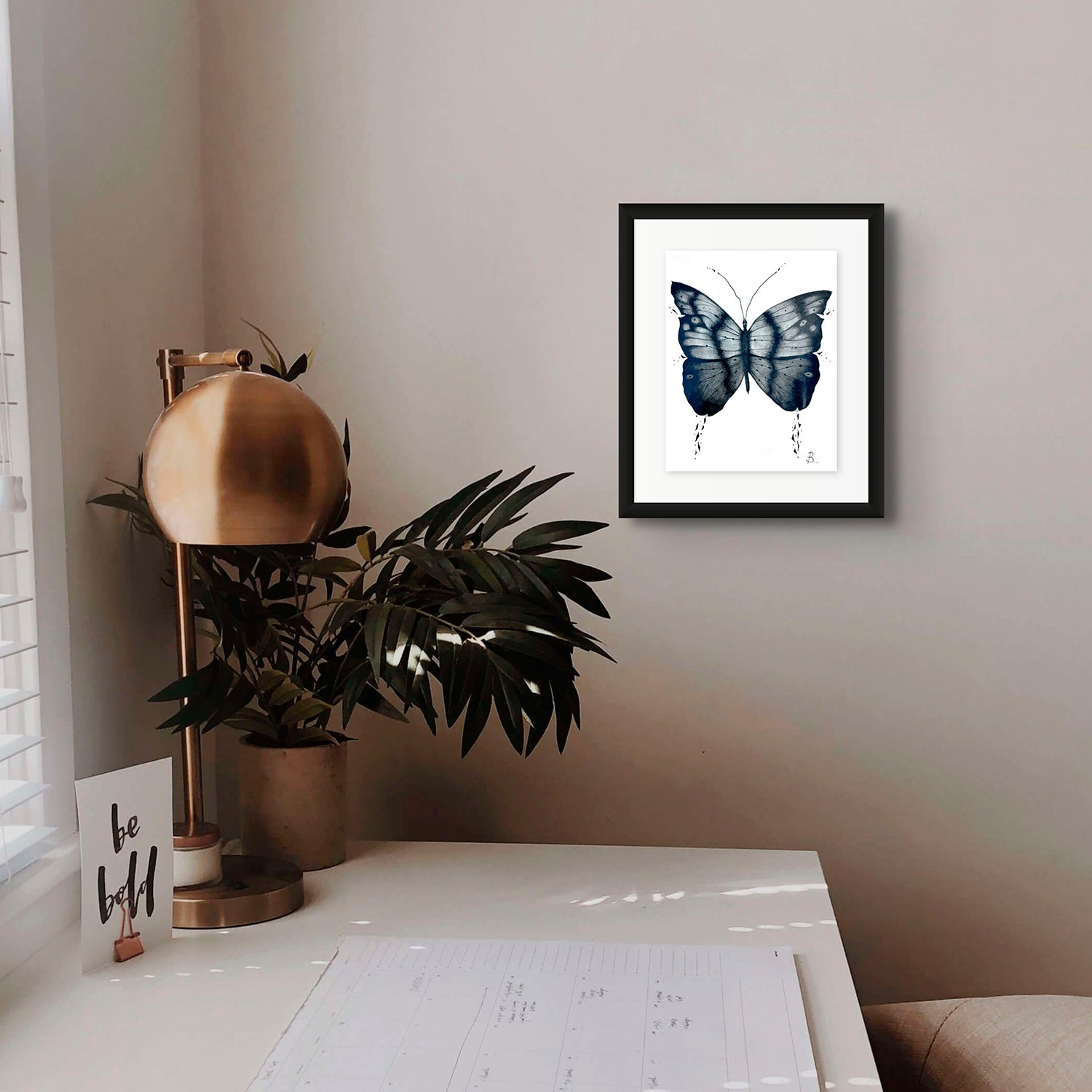 'Mythical Butterfly' original graphite pencil art on paper by Bridget Bradley. Seen framed in black and hanging in a home office space. Learn more