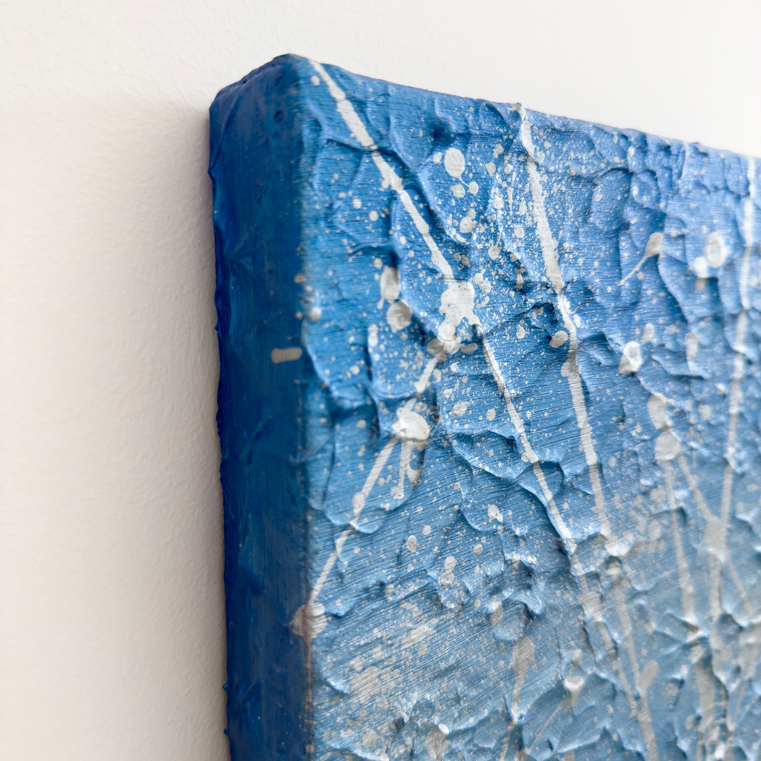 'Ocean Mist' abstract expressionism artwork top right edge of canvas. In soft blue and silver hues with silver marks. An original painting by Bridget Bradley. Explore details now.