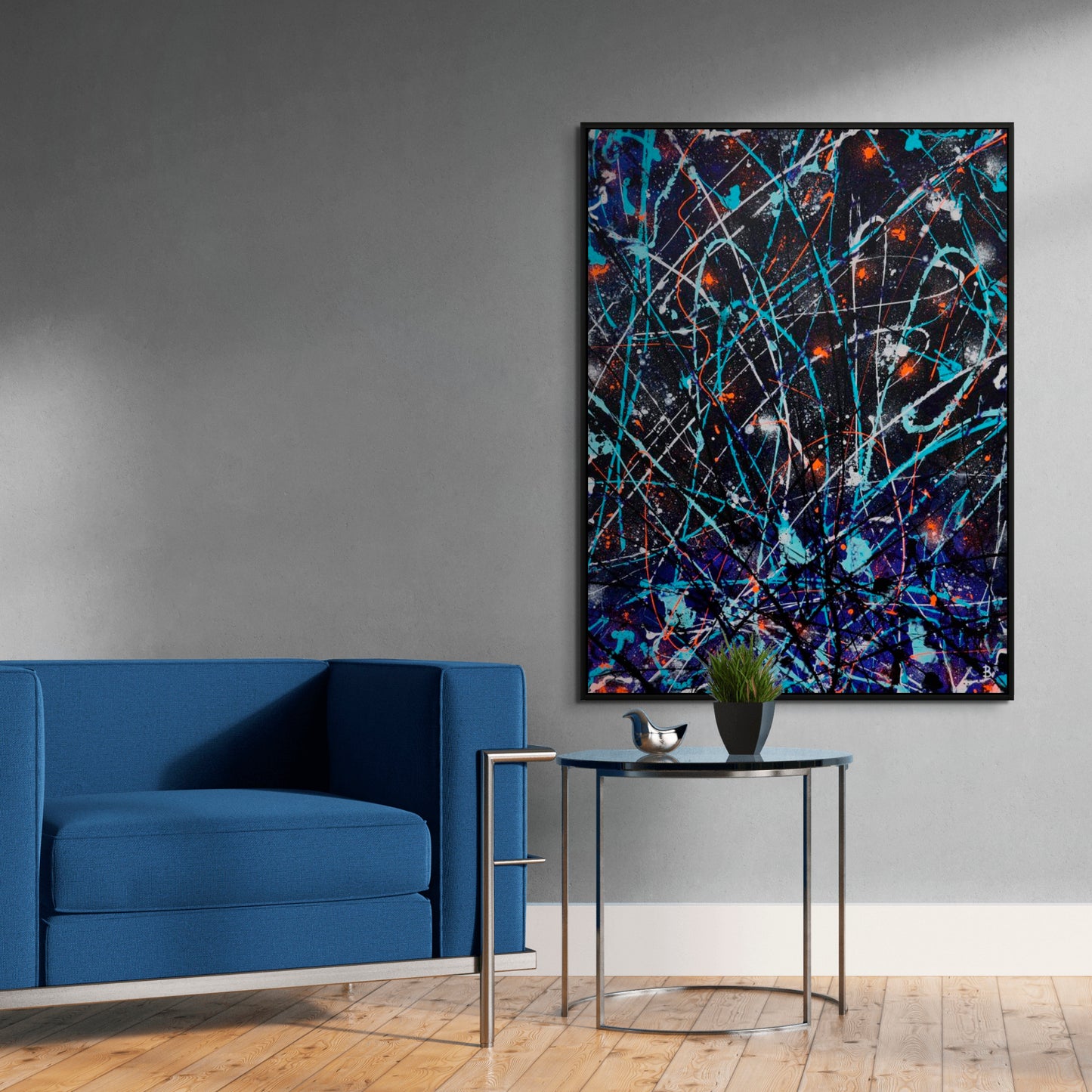 'Satellite' Original Abstract Painting seen Framed in Black Timber frame hanging near a Blue Chair. Hand painted on canvas by Bridget Bradley. Learn more.