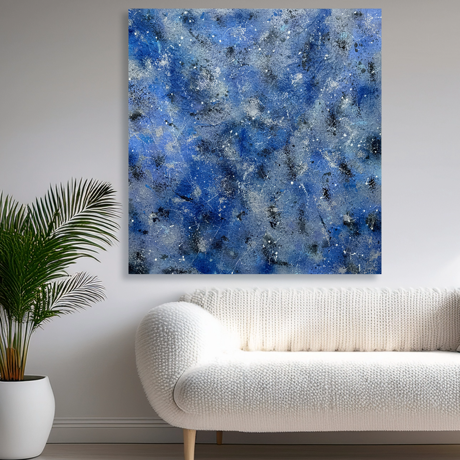 'SILVER RAIN II' Original Abstract Expressionism Painting on canvas in blue, silver, white and black hues hangs in situ above an off white sofa near a palm pot plant. Painting hand-painted by Brigdet bRadley