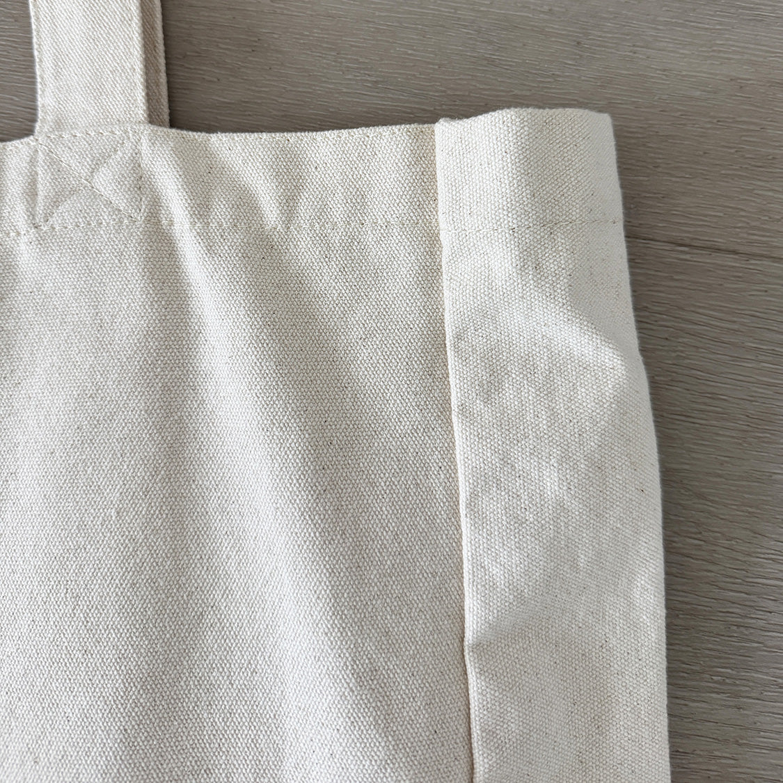 Closeup Image of Exclusive  Premium Canvas 'A Horse's Soul' Tote in Ecru showing strong stitching and side panel gusset. 