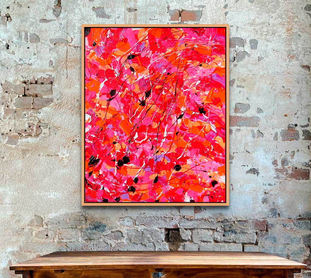 'Sunset Desert' original abstract expressionist painting on canvas by Bridget Bradley seen hanging in situ on brick wall above wooden table.