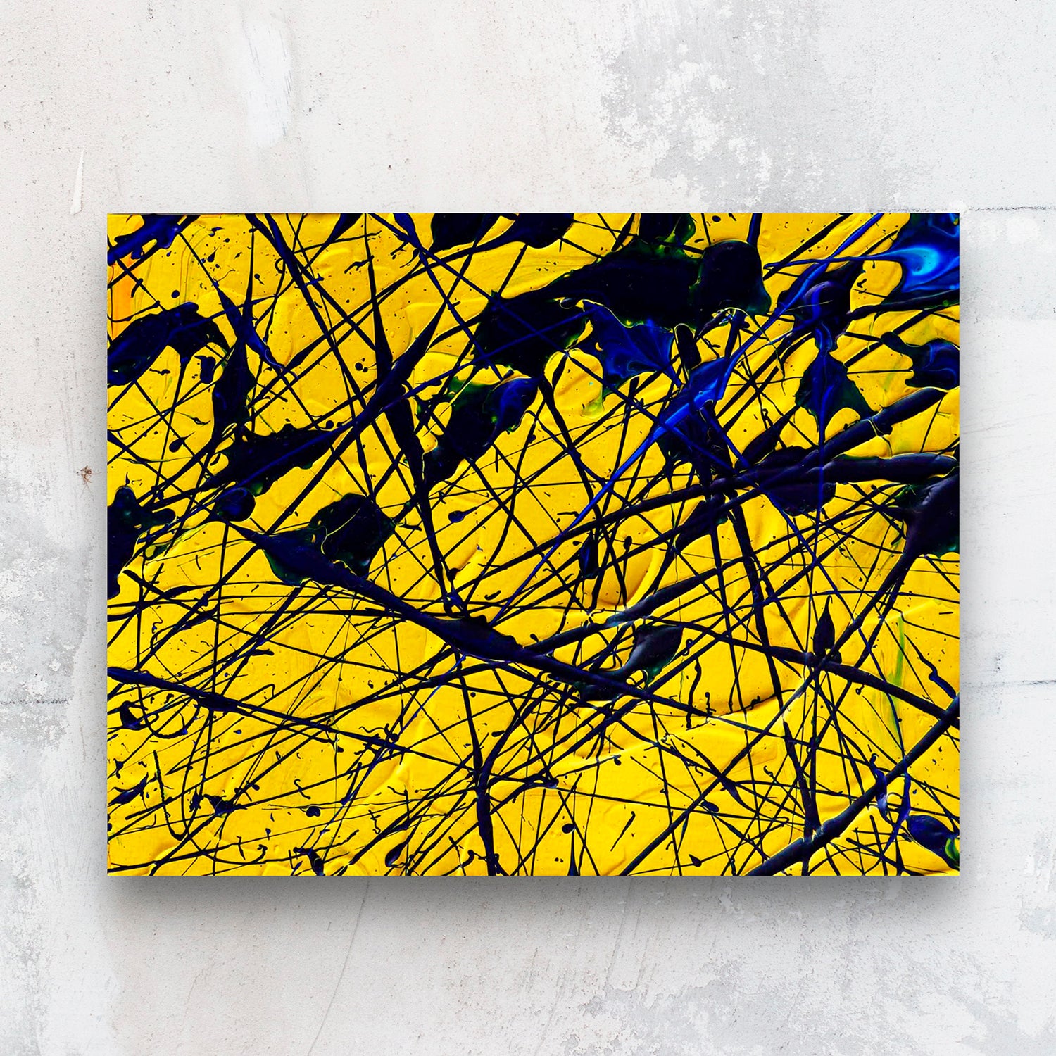 Yellow-Original Painting on Paper by Bridget Bradley, seen unframed against a stone wall.