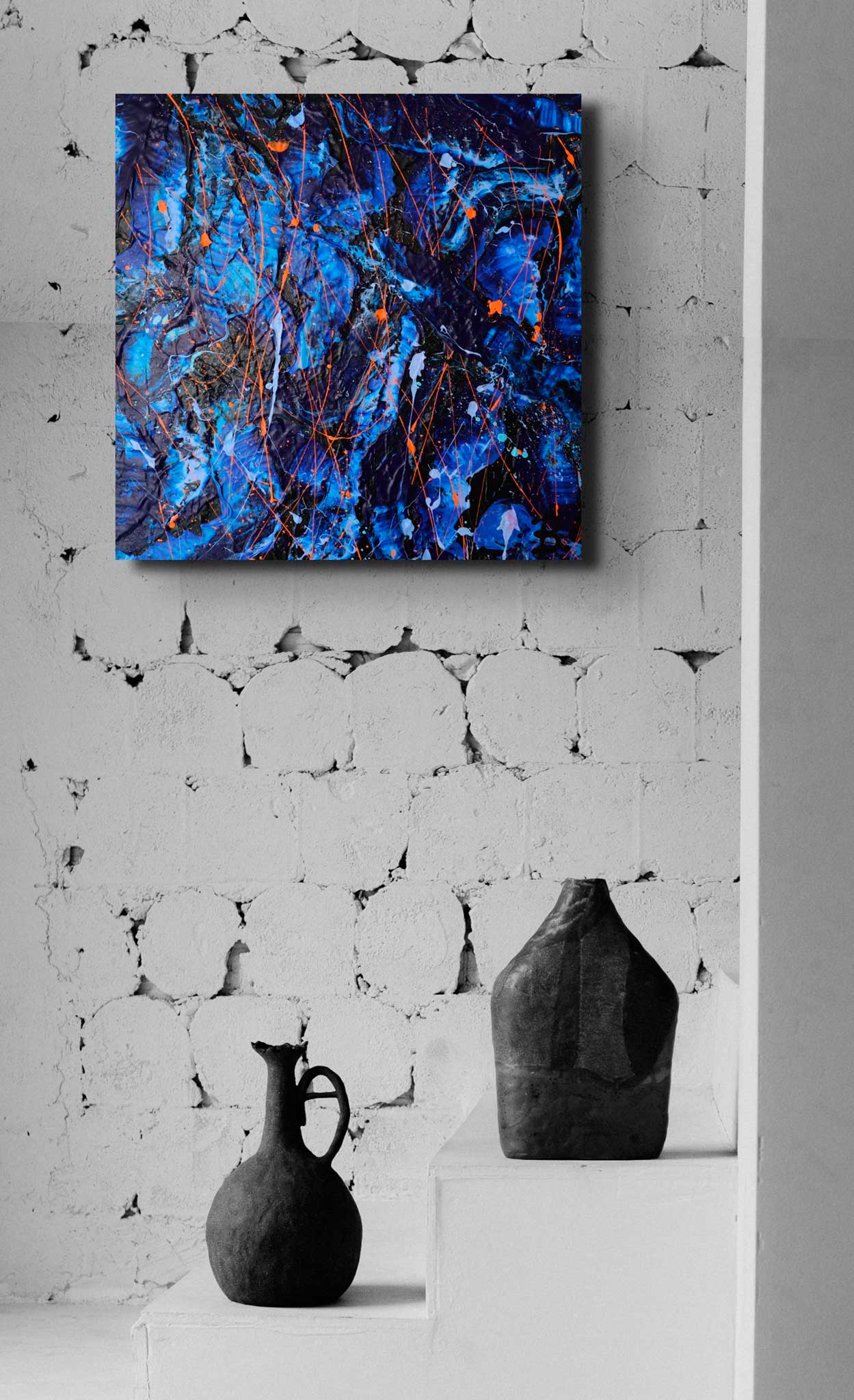 'Enigma' a commissioned abstract painting by Bridget Bradley. Heavy texture abstract on canvas seen hanging on light brick wall with black vases below on stairs.