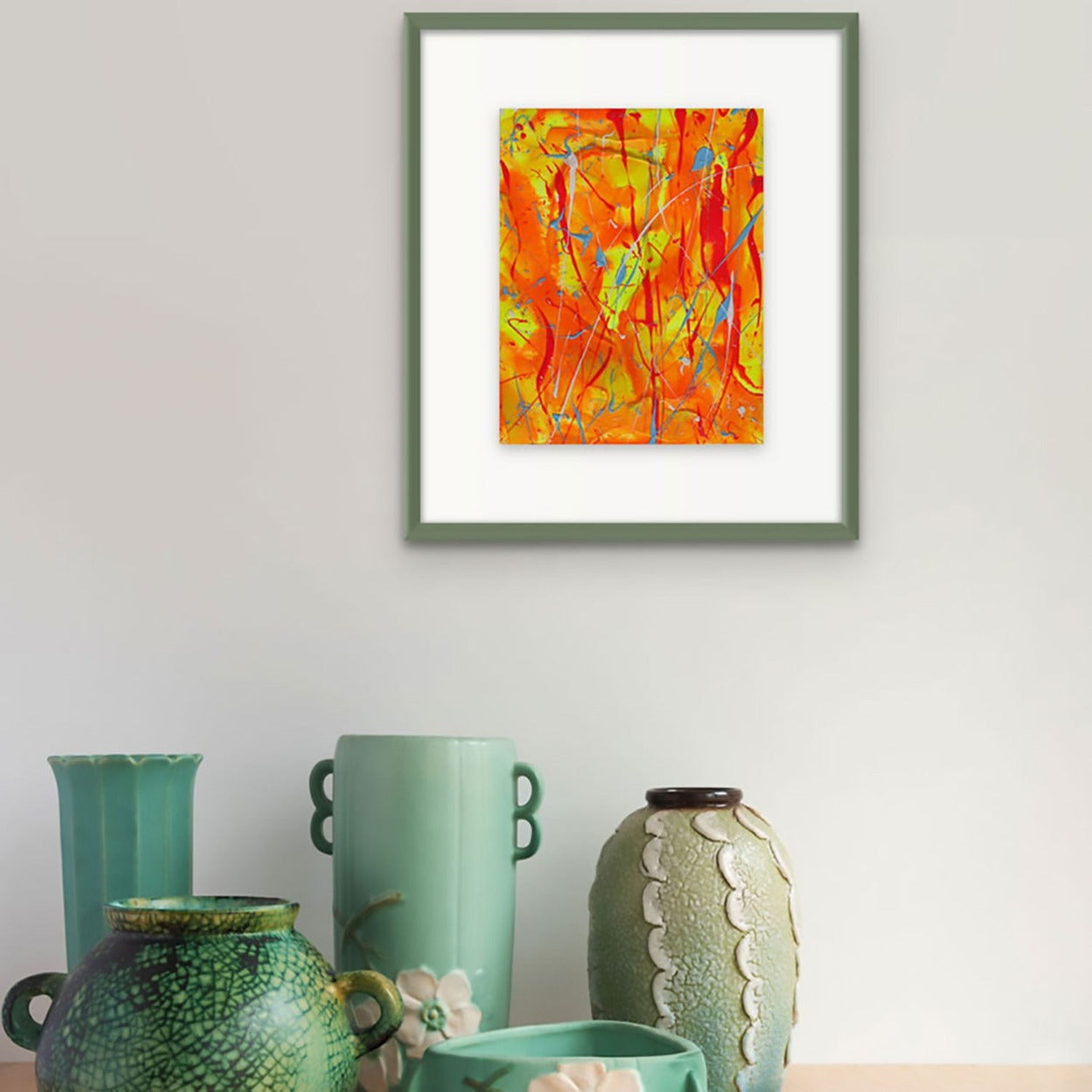 Fire, painting seen as framed in green with white mat hanging on wall. Unique abstract art on paper by Bridget Bradley
