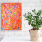 Happiness, original abstract canvas painting, visualized hanging on white brick wall with plant. Abstract art by Bridget Bradley