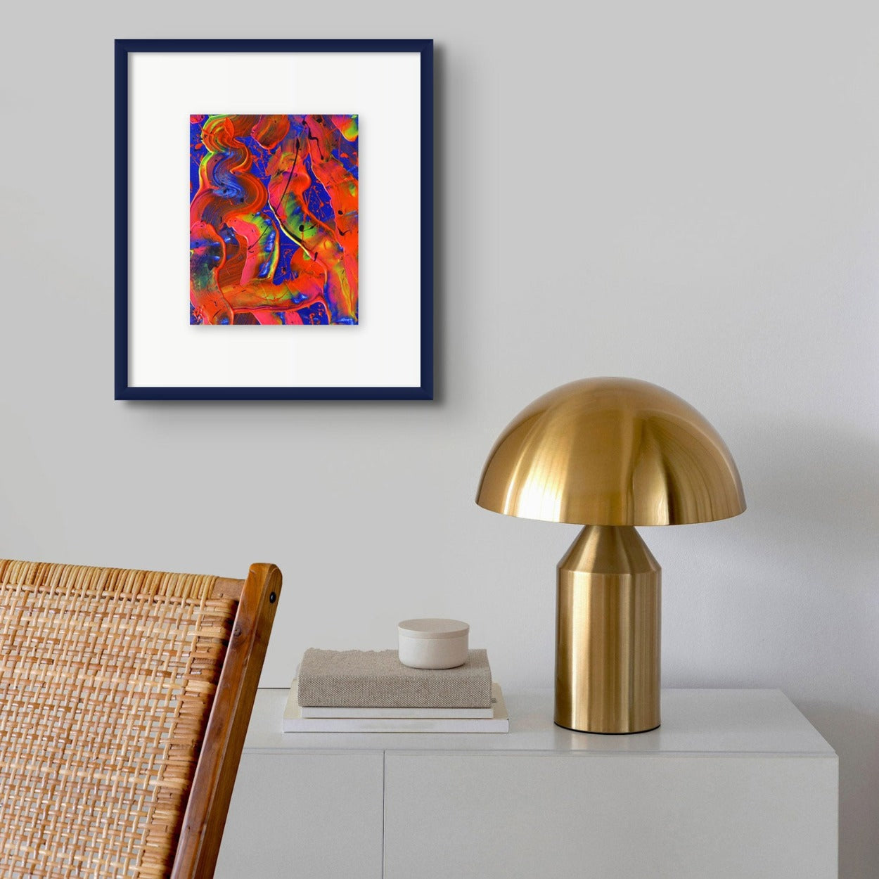 Little Luxuries I , original abstract art by Brigdet Bradley seen in situ on wall in navy frame with gold lamp and rattan chair