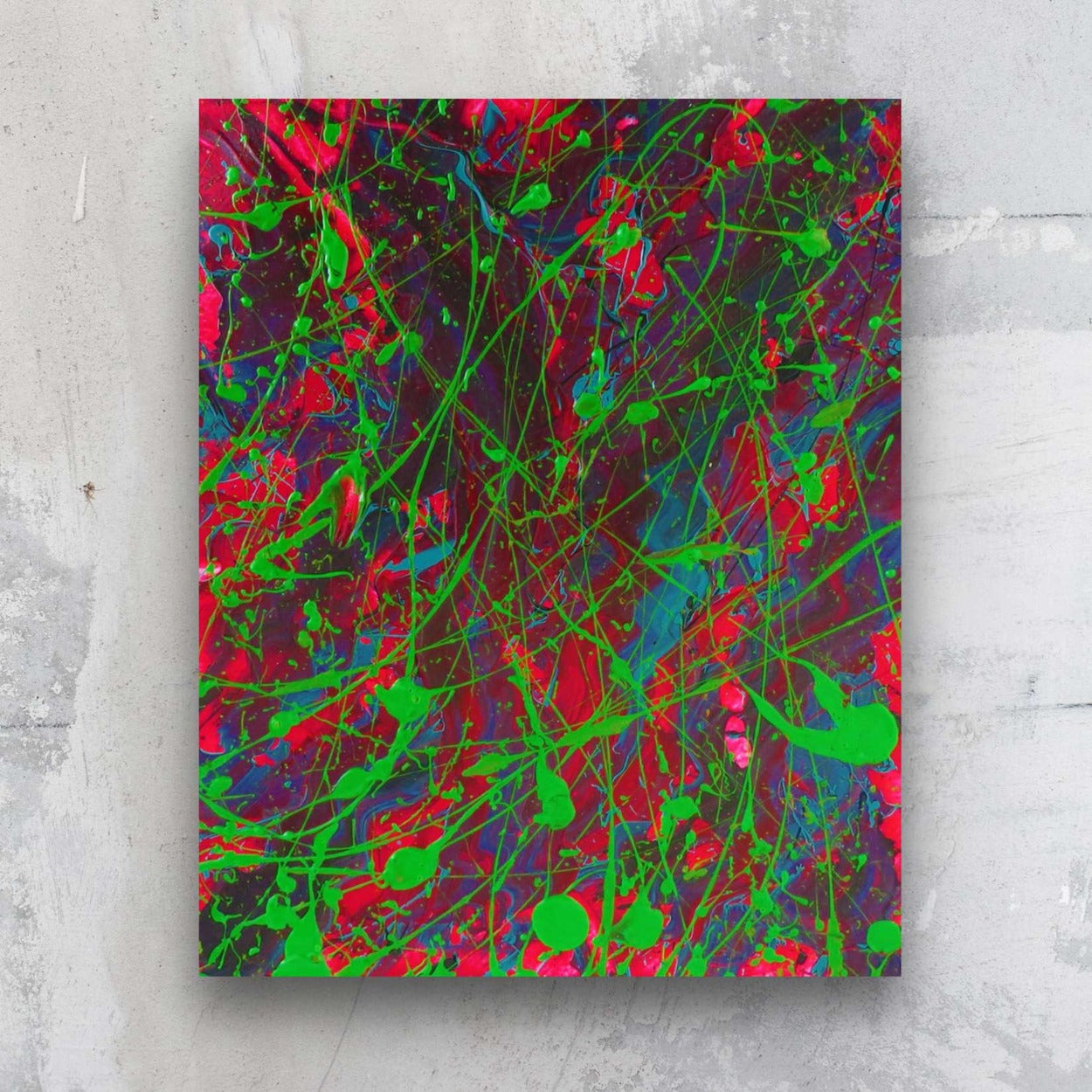 Little Luxuries XVI abstract art on paper in vibrant greens, neon pinks and teals by Brigdet Bradley. Seen against stone wall.