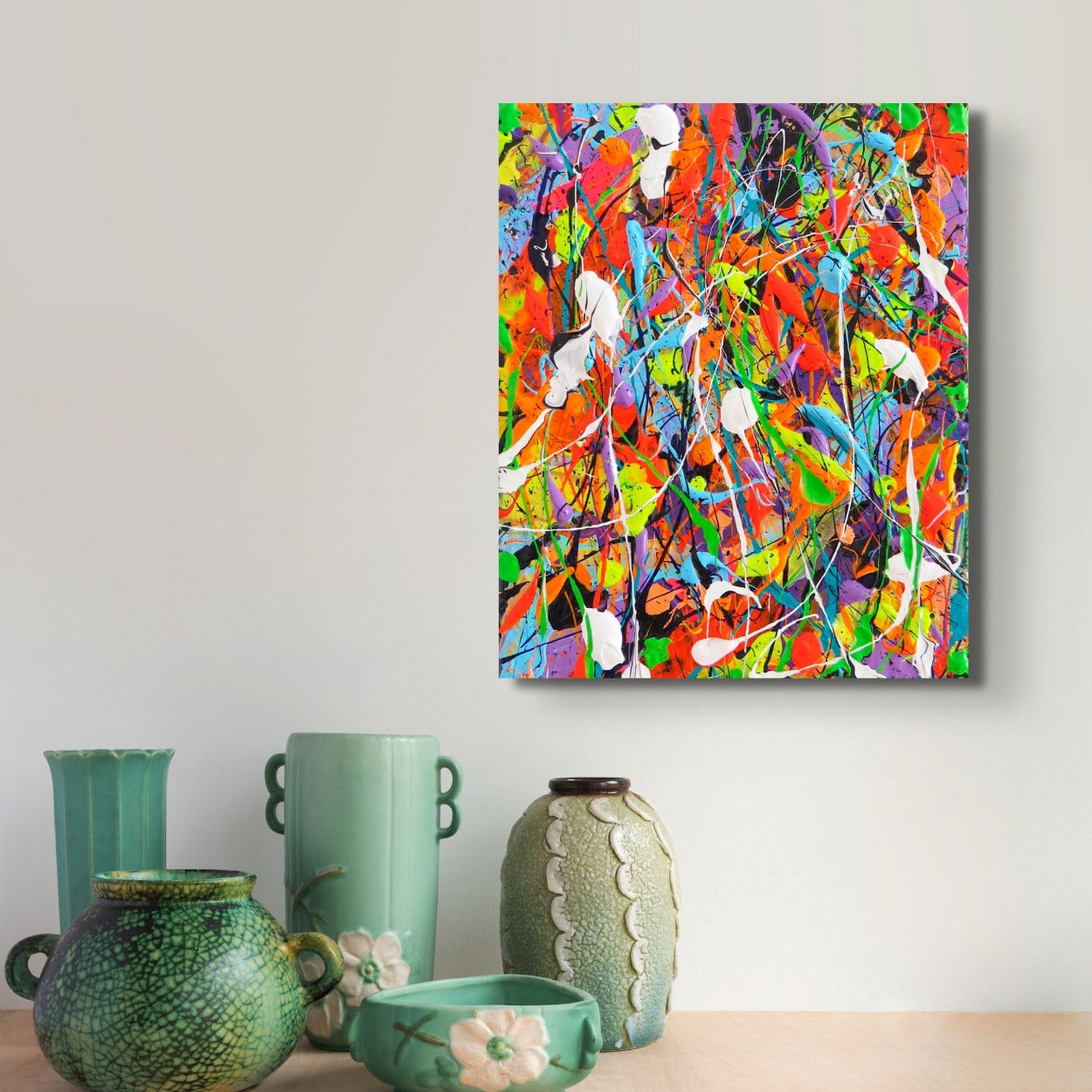 Night at the carnival, original, bright, textured abstract painting seen hanging above green vases. Art by Bridget Bradley, contemporary Abstract Artist Australia