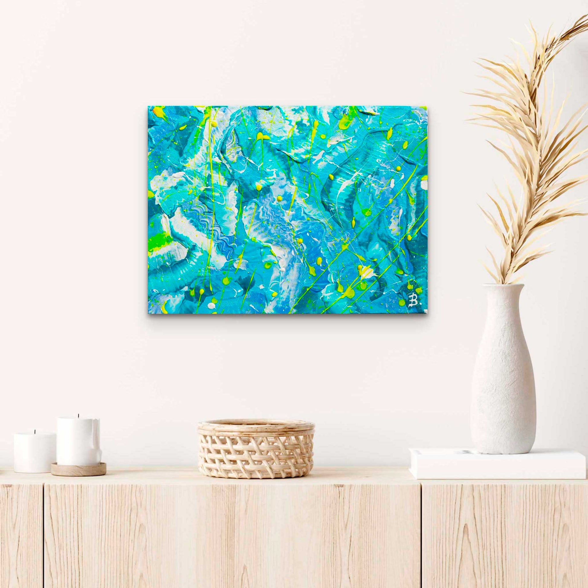'Ocean' an original abstract painting on canvas by Bridget Bradley. Blues, aquas, whites and neon yellow colour palette make this an uplifting artwork. Seen hanging in situ above blonde wood console with beach house decor