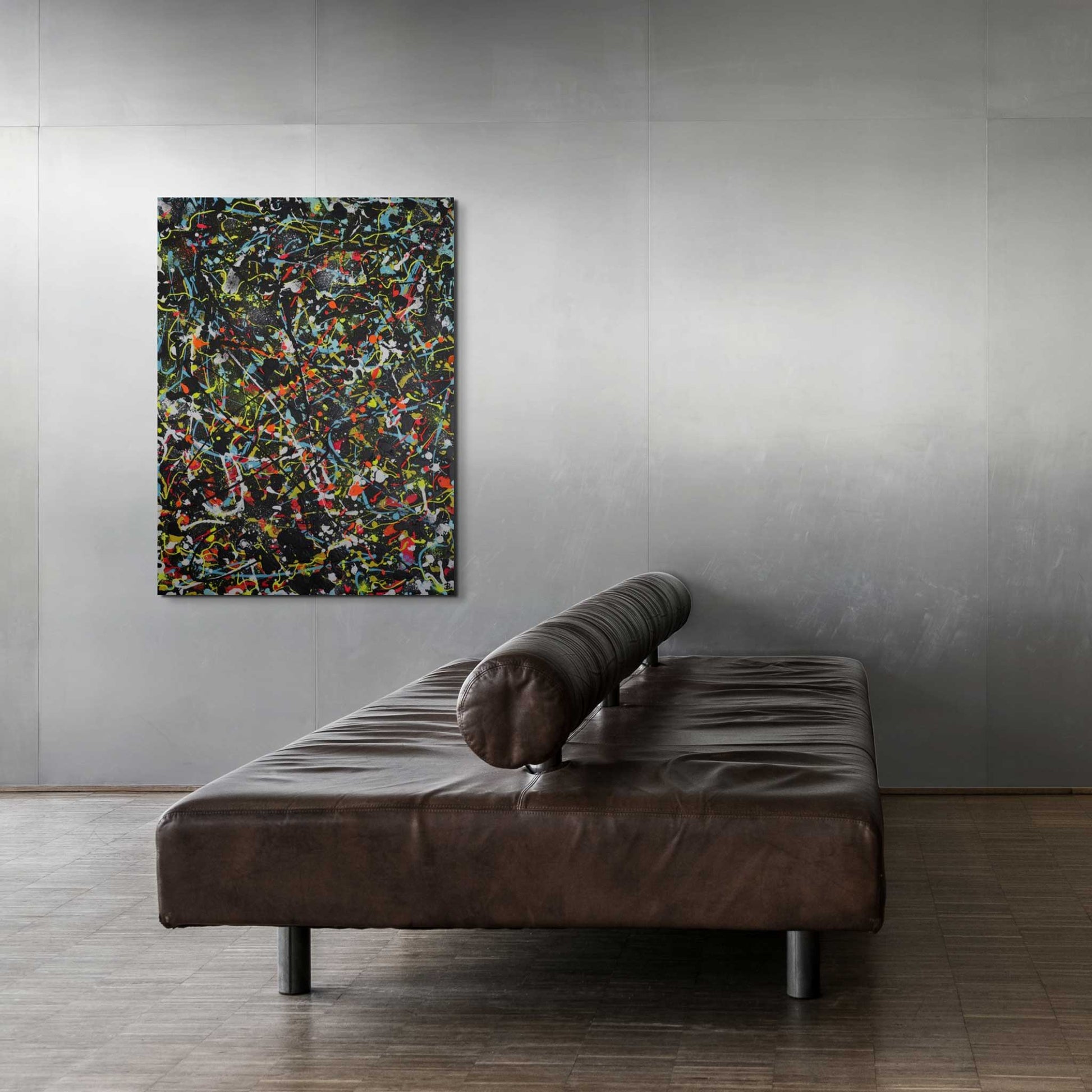 Onyx, original abstract painting seen hanging in minimalist space on concrete wall with brown leather sofa. Art by Bridget Bradley