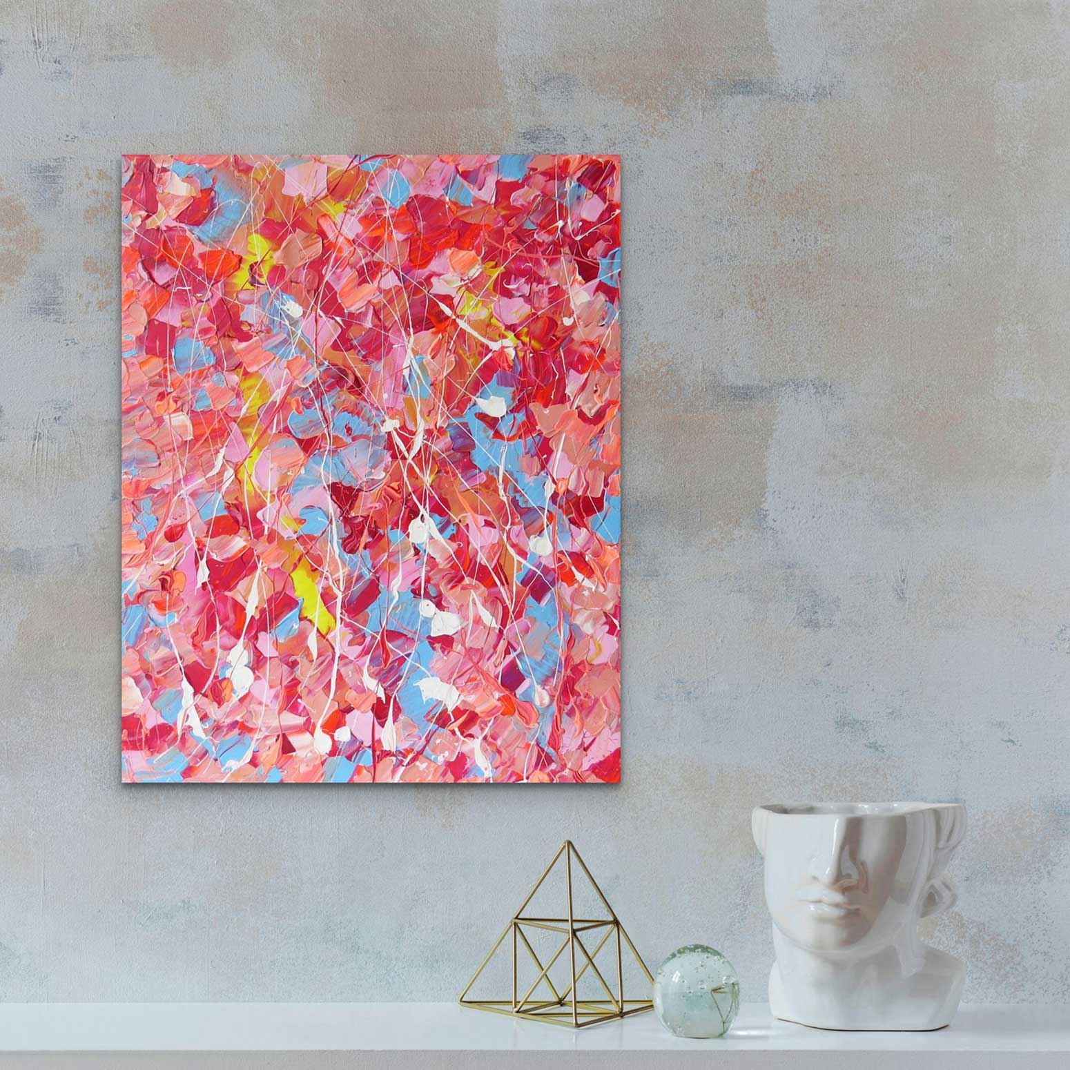 Pink Lake, textured abstract painting, pinks, nudes, reds, blue, yellow and white palette. Seen in situ against concrete wall with modern decor.